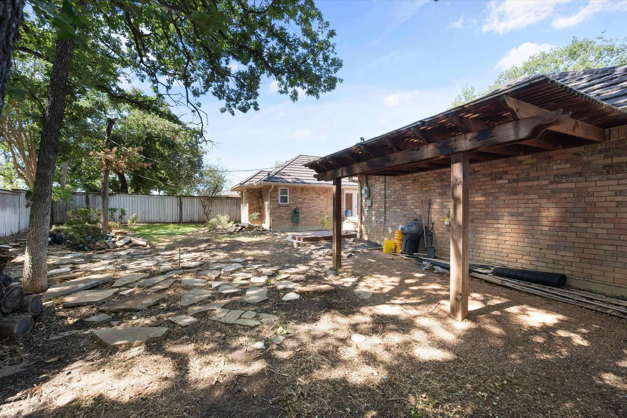 Brick exterior with an attached wooden pergola