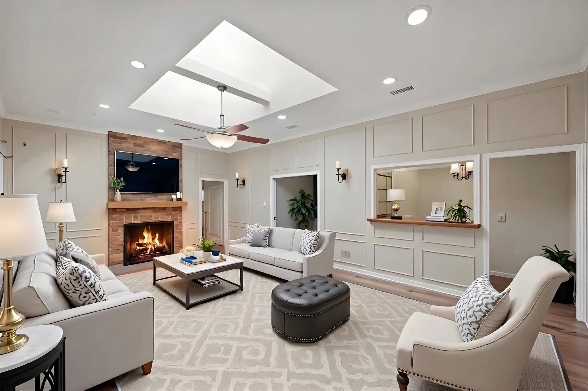 VIRTUALLY STAGED.... Recessed lighting, ceiling fan, brick fireplace with wood mantel, wall paneling, and an interior pass-through window with wood countertop  Wet Bar room
