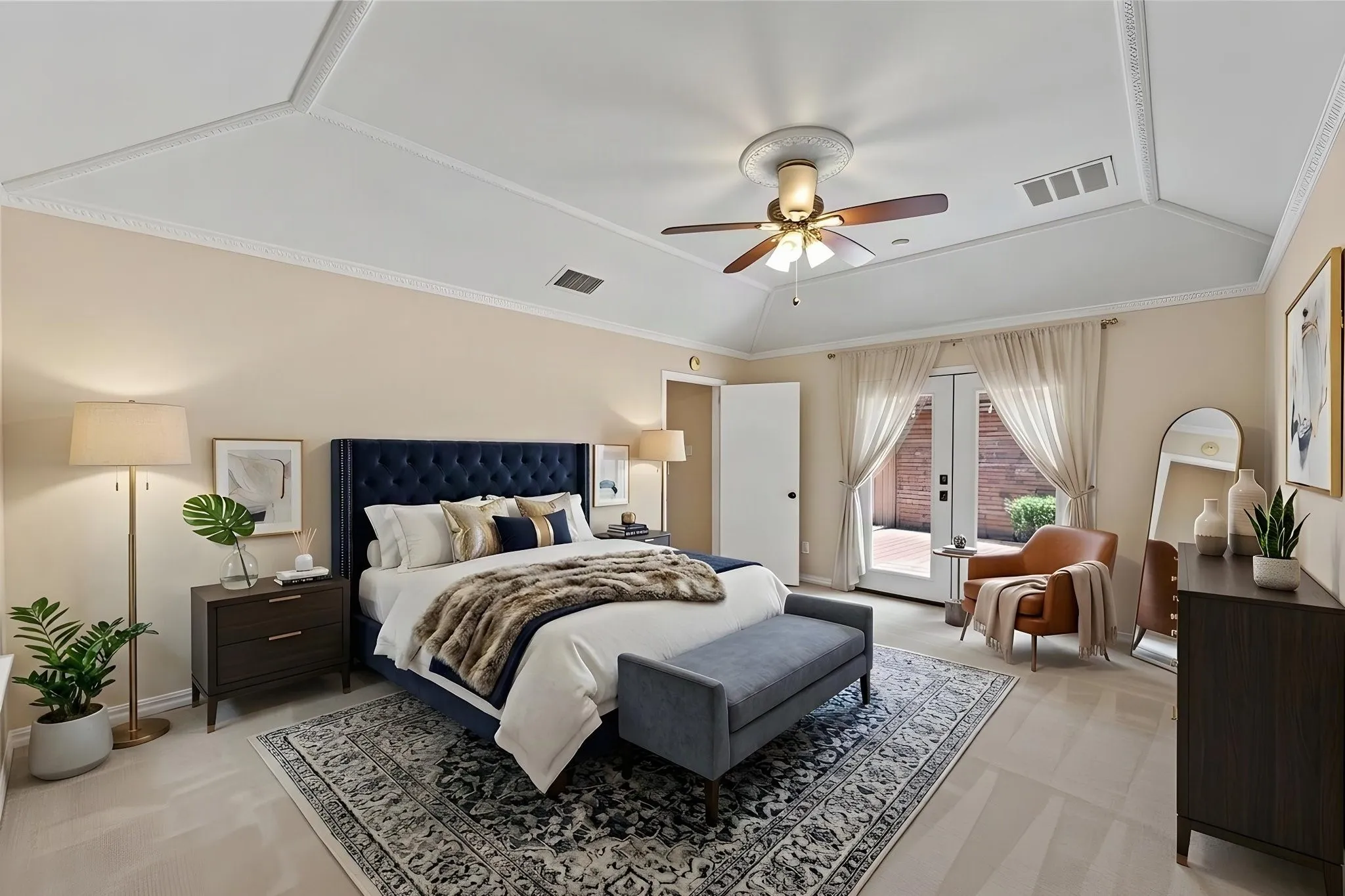 VIRTUALLY STAGED Tray ceiling with decorative molding, ceiling fan, carpet flooring, and French doors to exterior