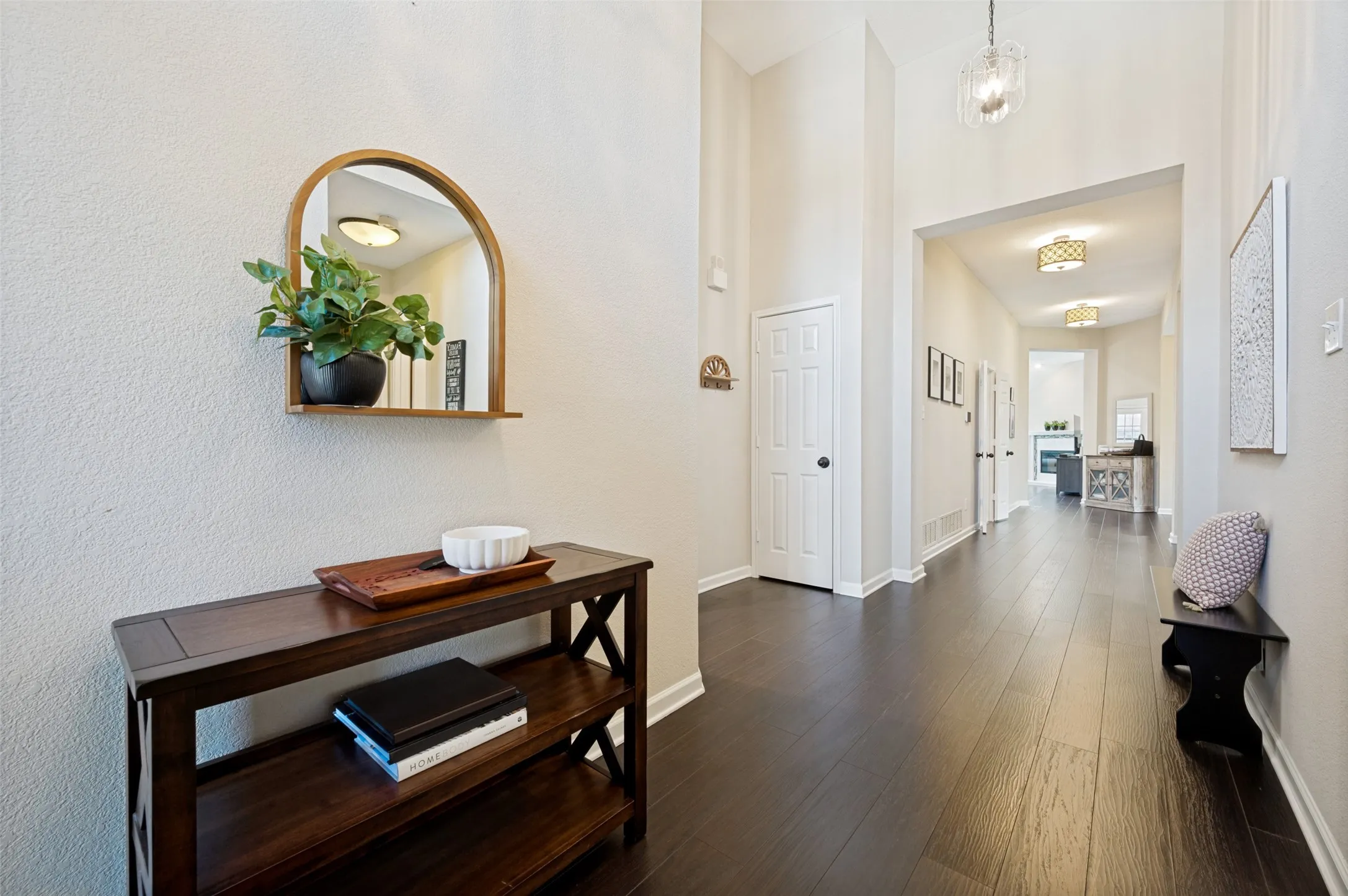 Dark wood-finish flooring throughout, light-toned walls, and recessed lighting