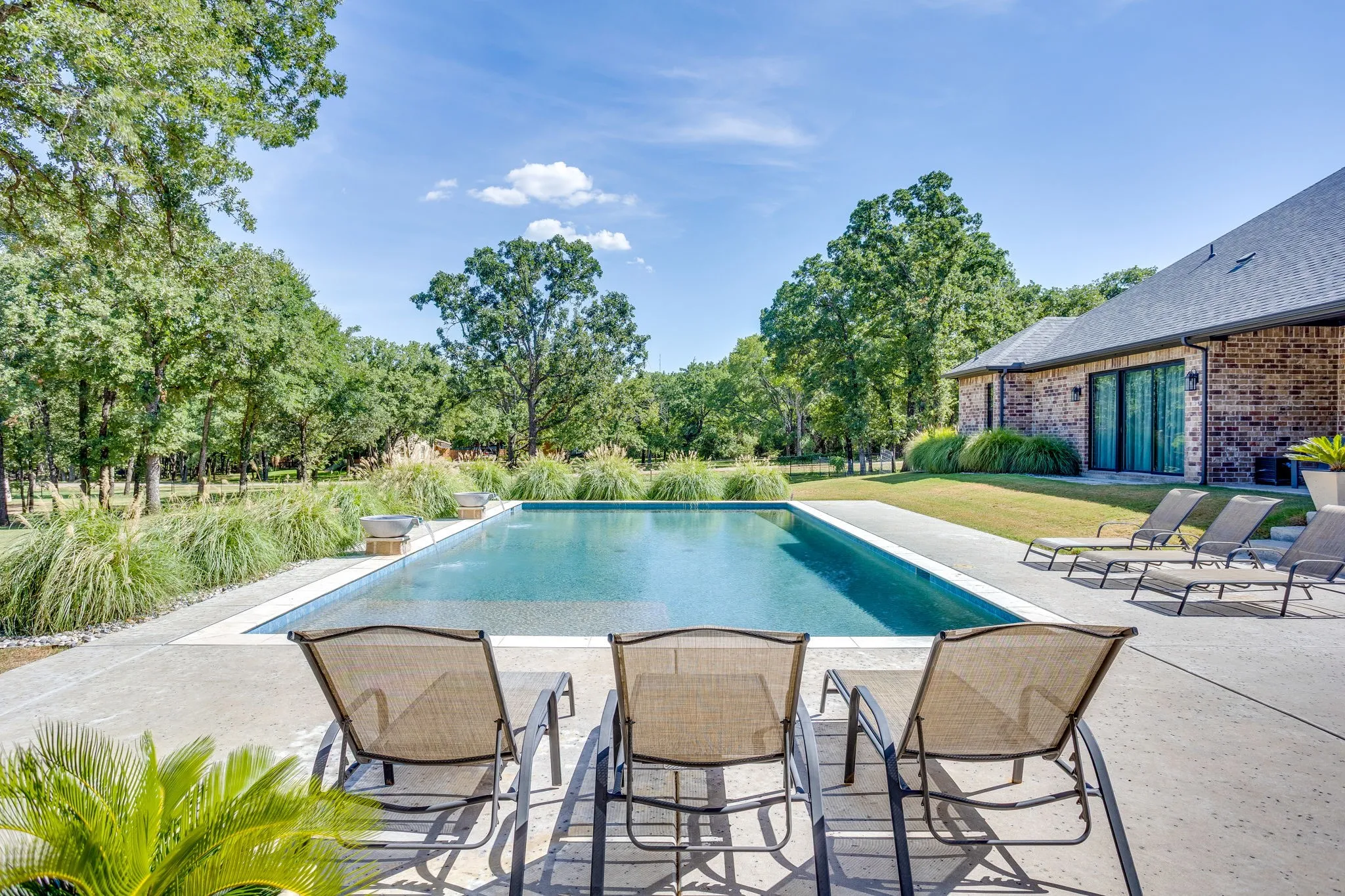 Rectangular swimming pool featuring a tanning ledge