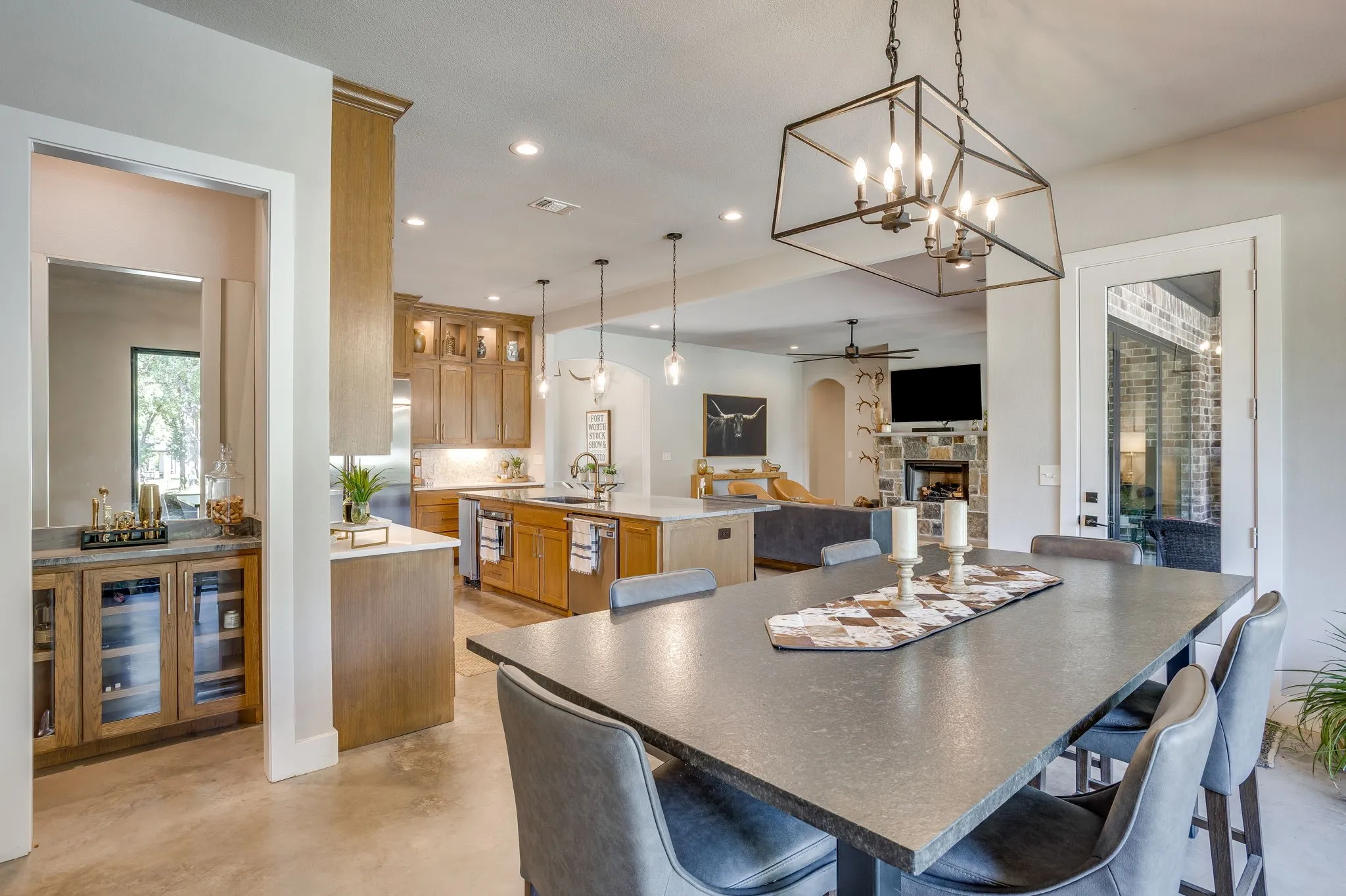 Dining area featuring beautiful light fixture open to kitchen and access to back patio