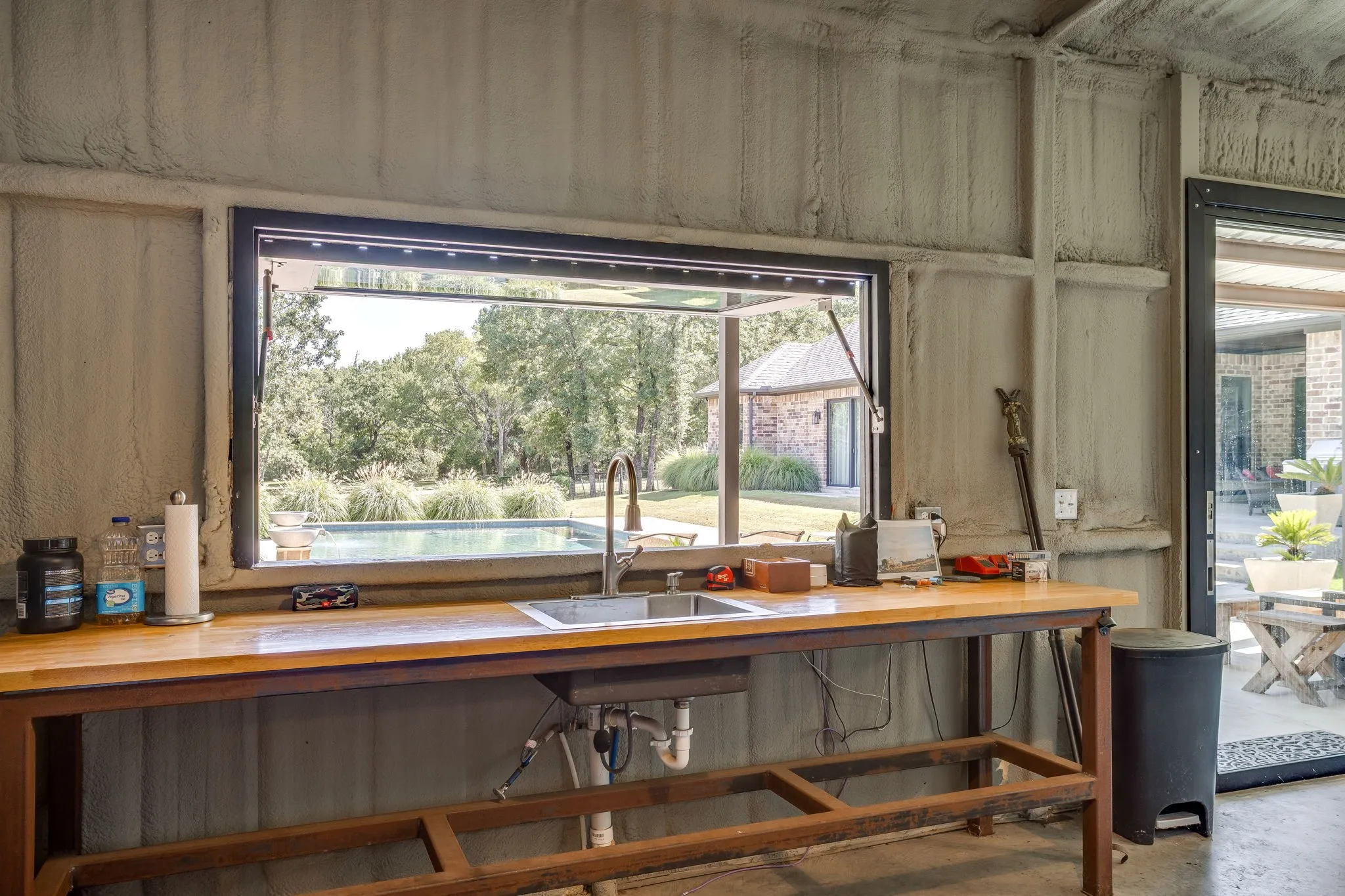 Pool house view of pass-through window and pool