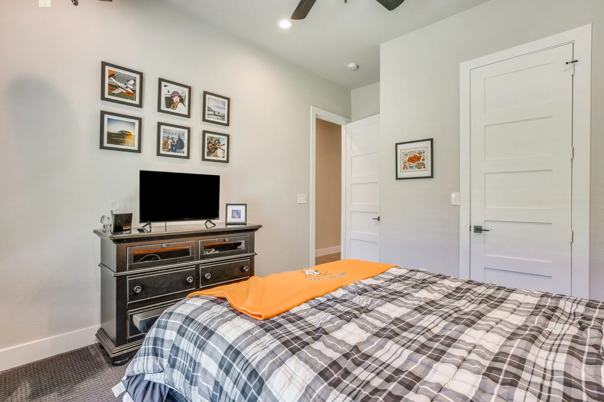 Recessed lighting, ceiling fan, and white paneled doors