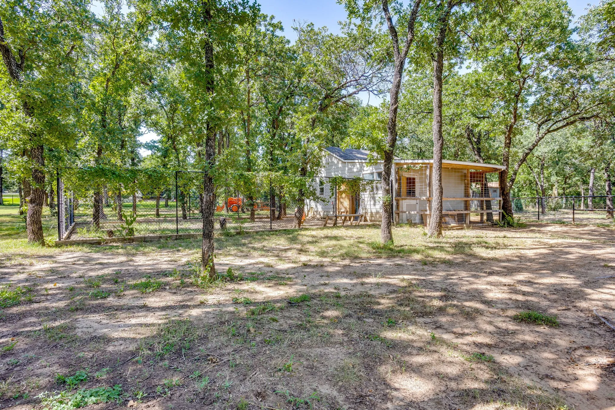 Chicken coop featuring a fully enclosed run, a workshop, and a separate storage shed for equipment
