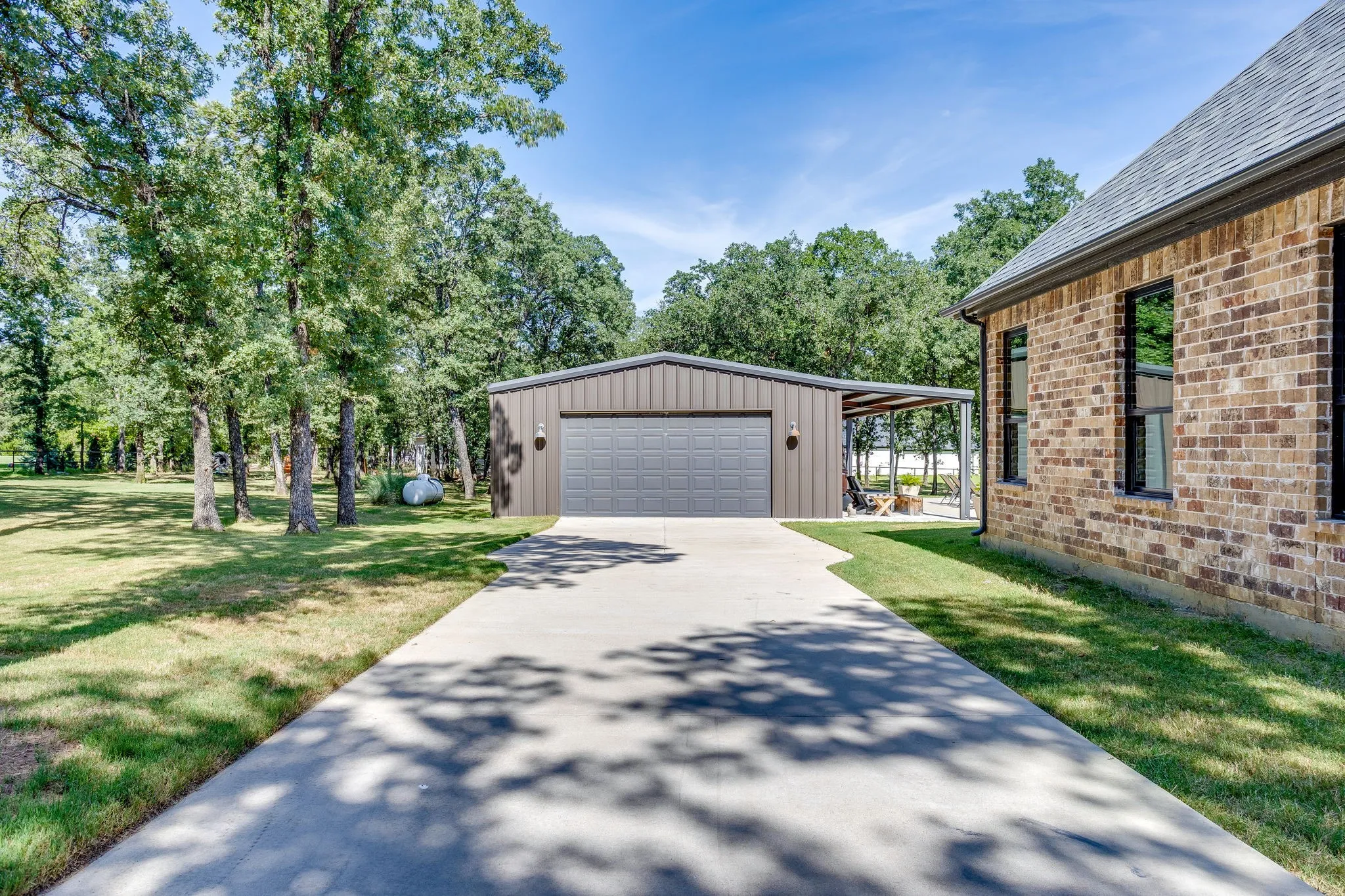 Alternate view of pool house featuring second driveway