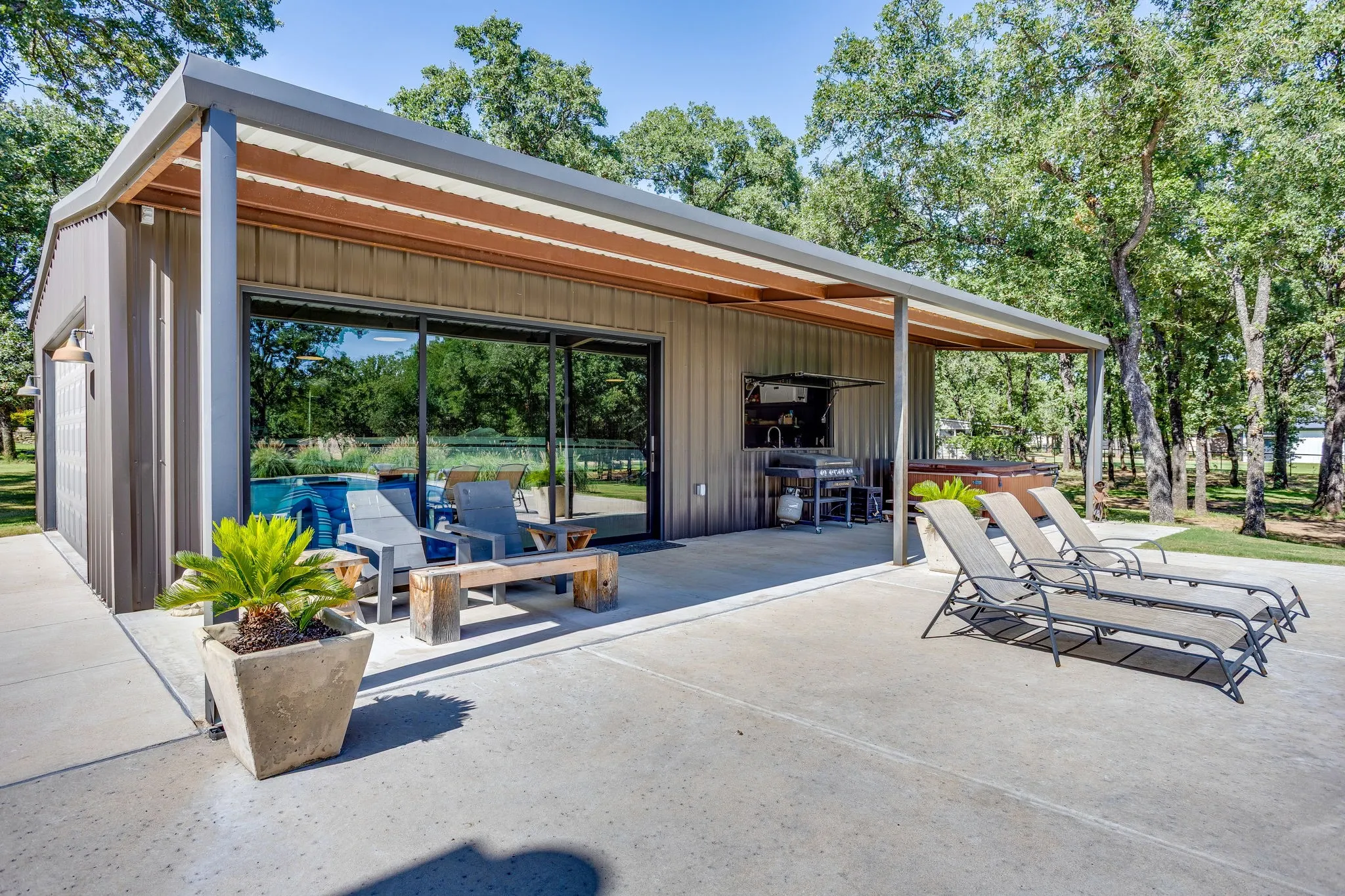 Pool house featuring large covered patio and pass-through window