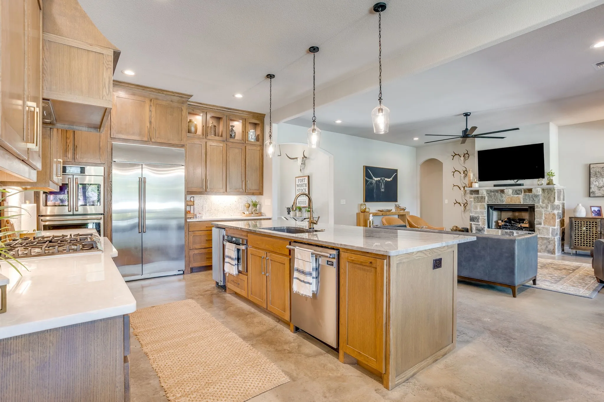 Gourmet kitchen with stainless steel appliances, a large central island, and stone countertops