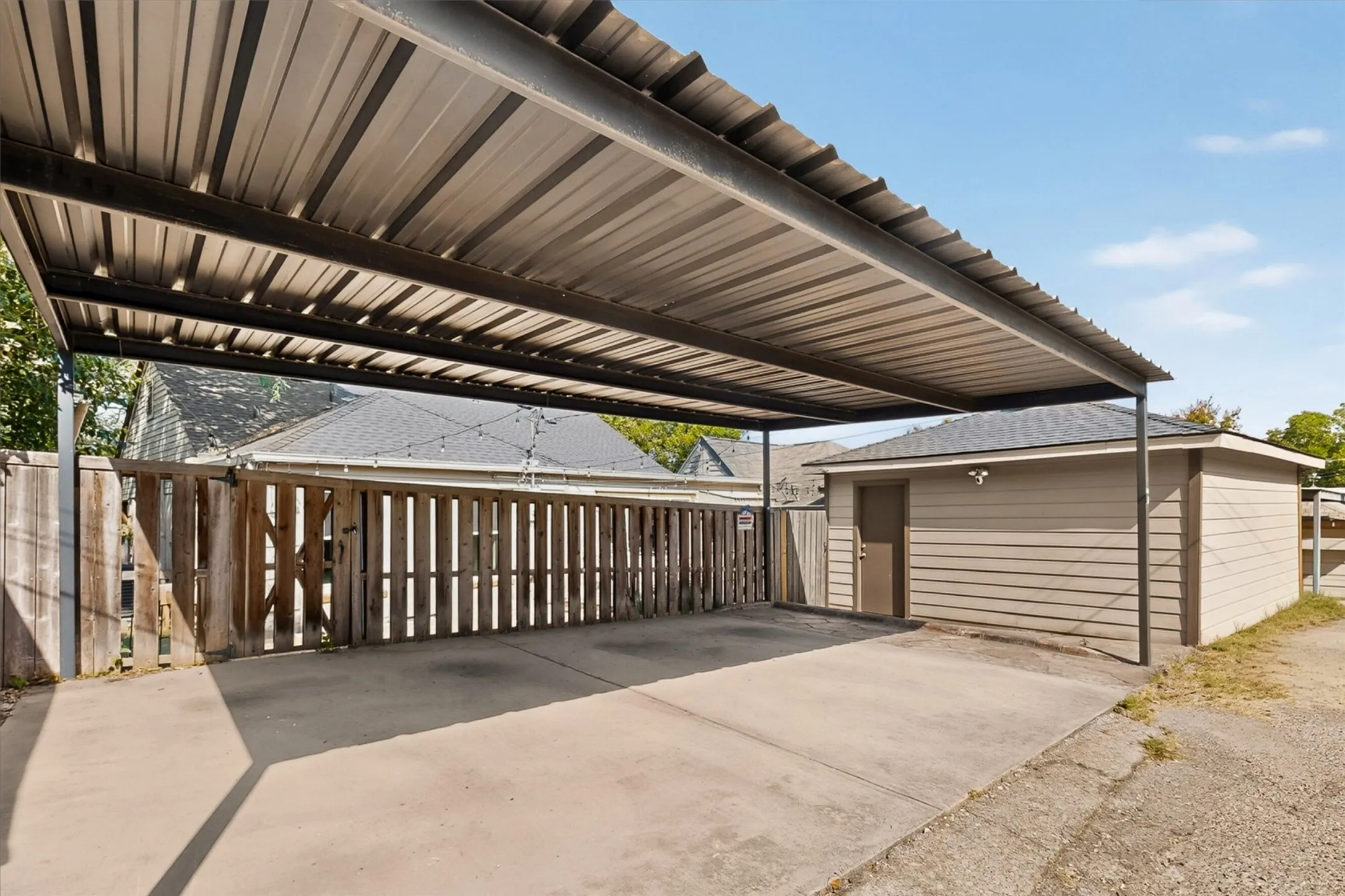 Tall two car carport in the back.