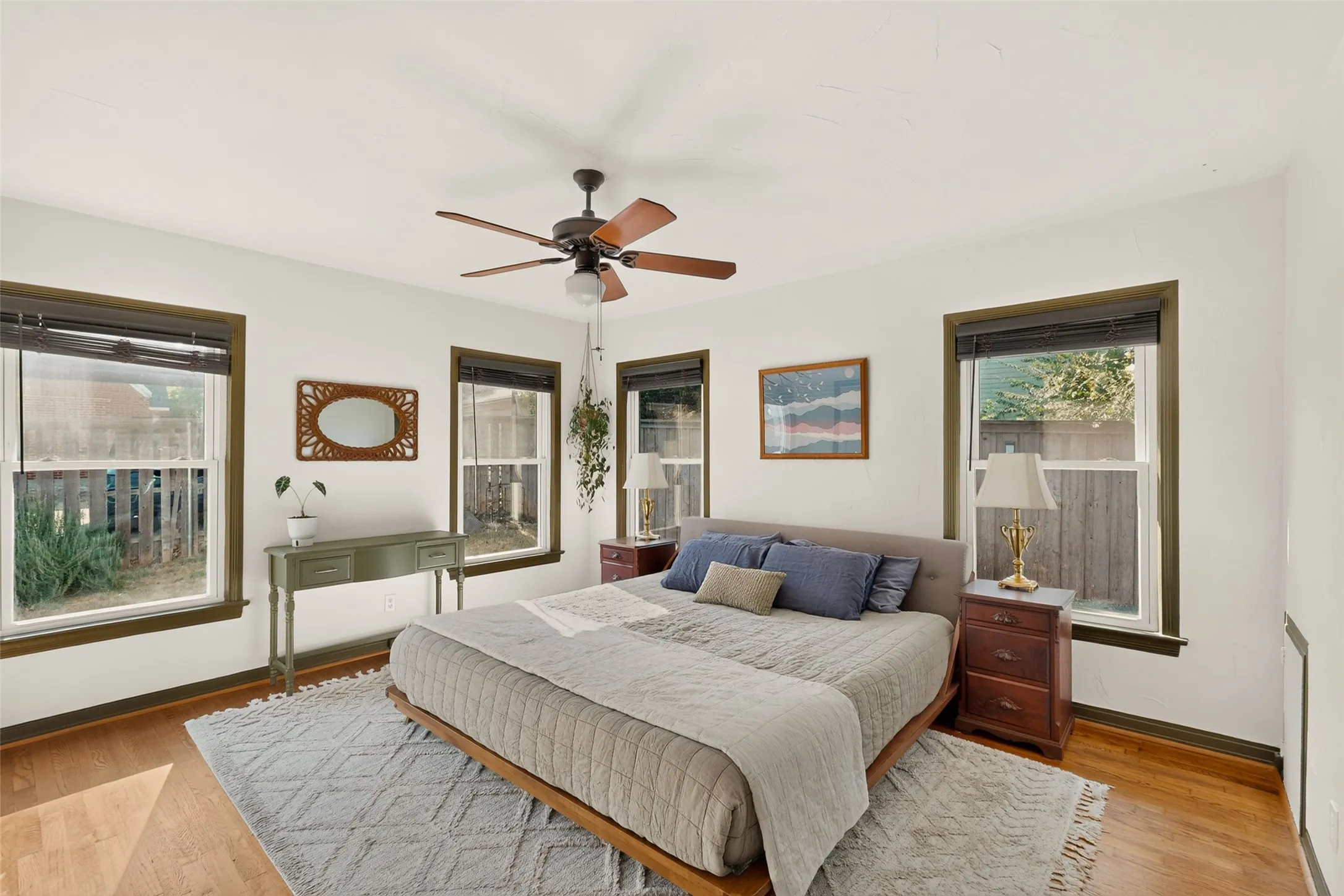 Generously sized primary bedroom has beautiful streaming light from it's east facing back windows