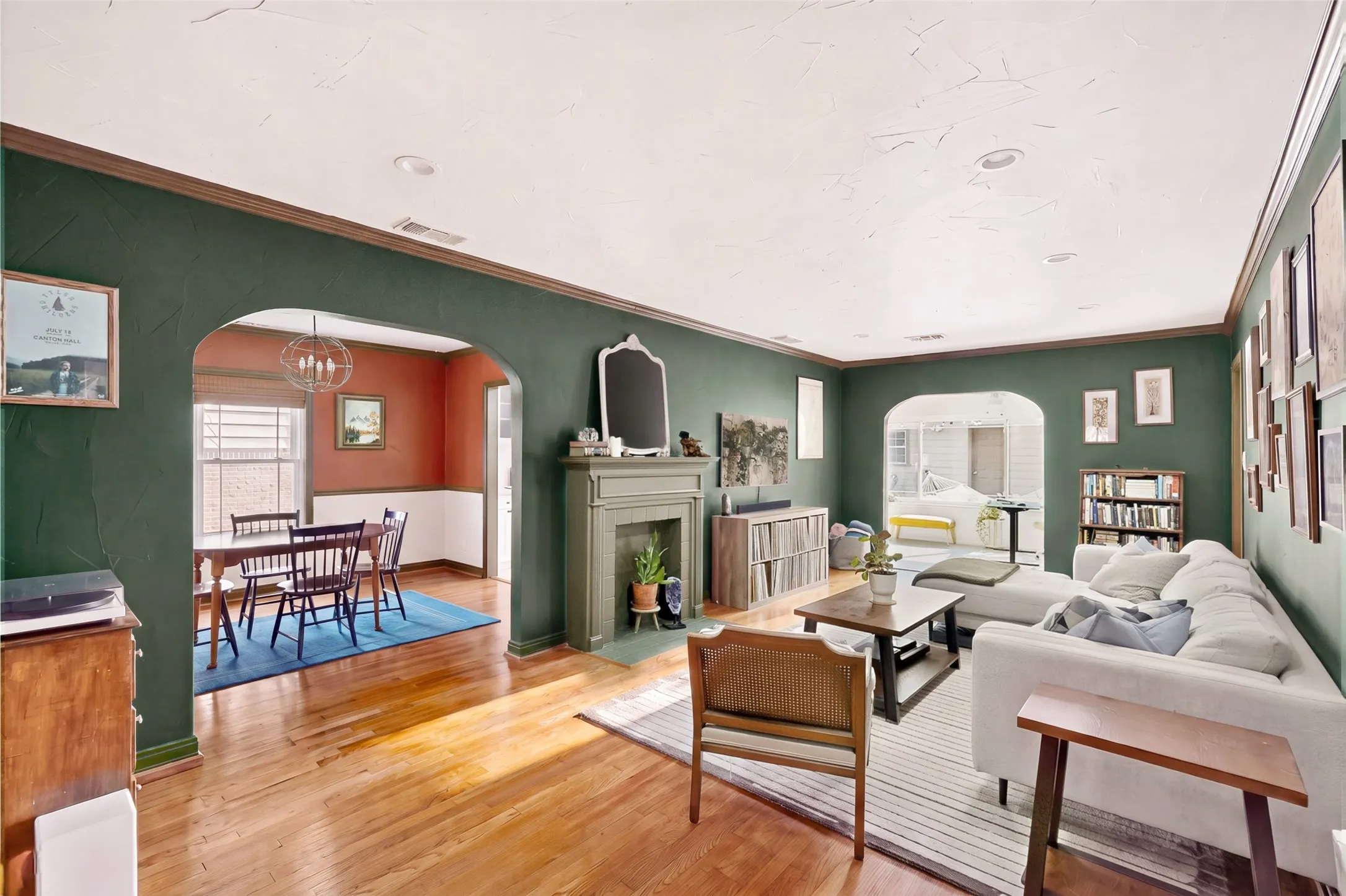 Period perfect paint colors and refinished original wood floors add extra charm to this spacious living room.