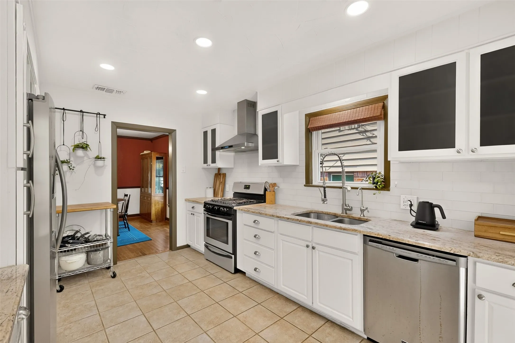 Double bowl sink with beautiful hardware and filtered drinking water. Stainless steel appliances includes a gas range.
