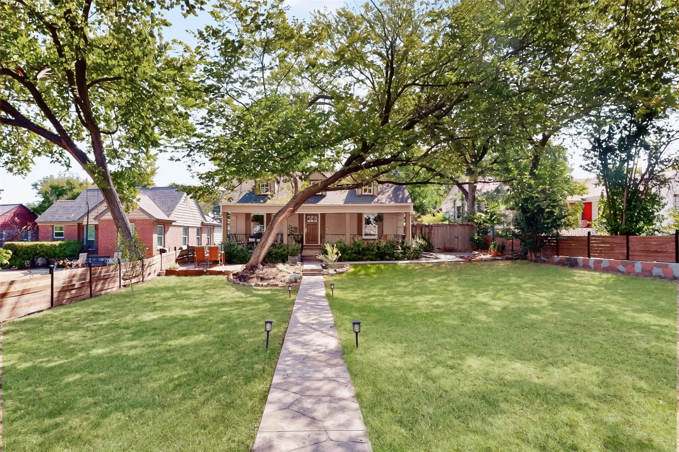 Front yard includes the beautiful arching elm and fruit trees and berry vines tucked in on the 1/4 acre lot