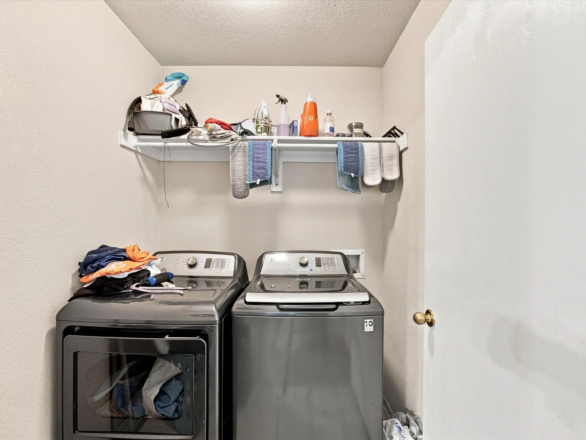 Utility area with a wall-mounted shelf