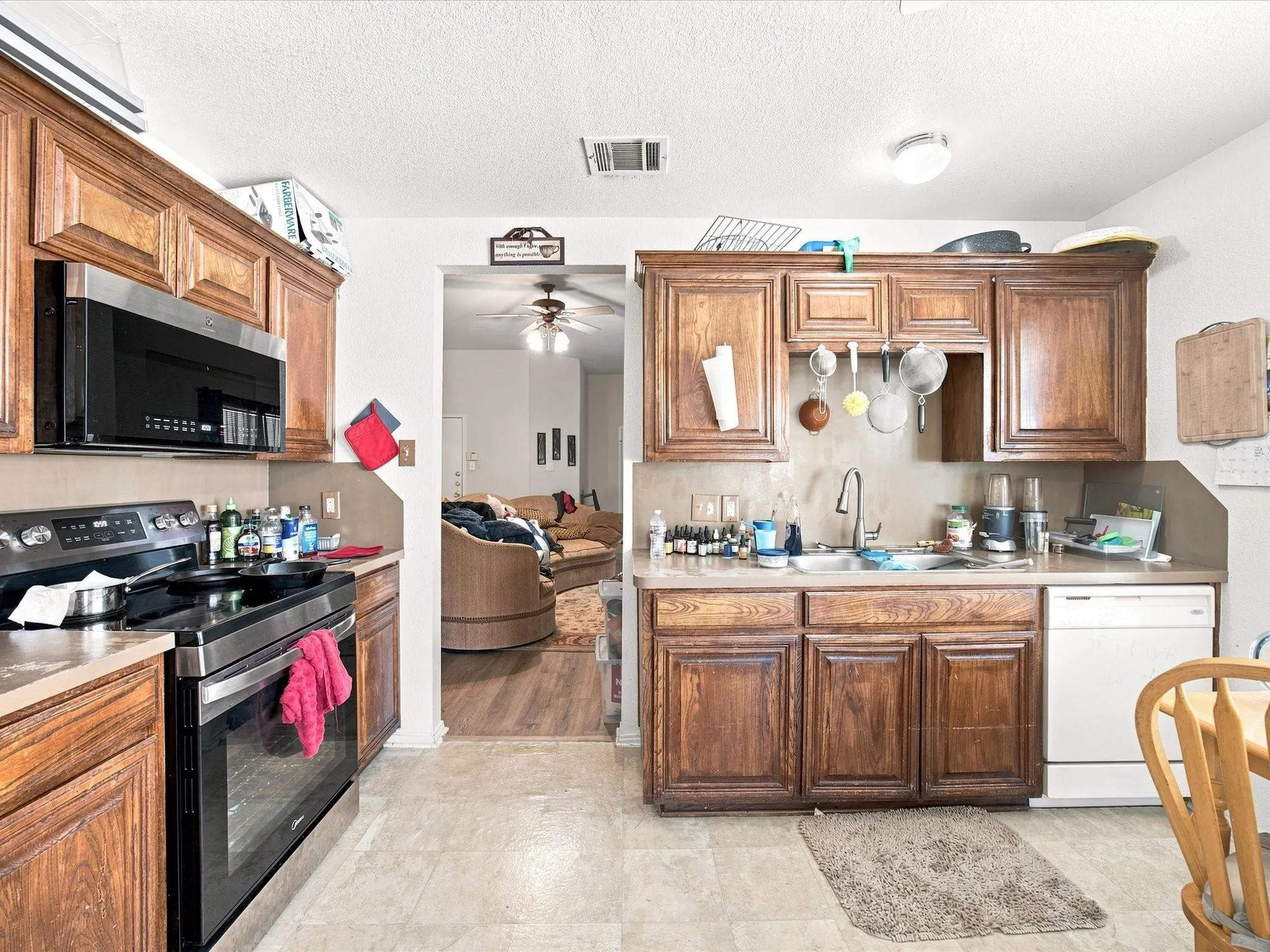 Kitchen featuring wood-finish cabinetry, stainless steel range, and stainless steel microwave