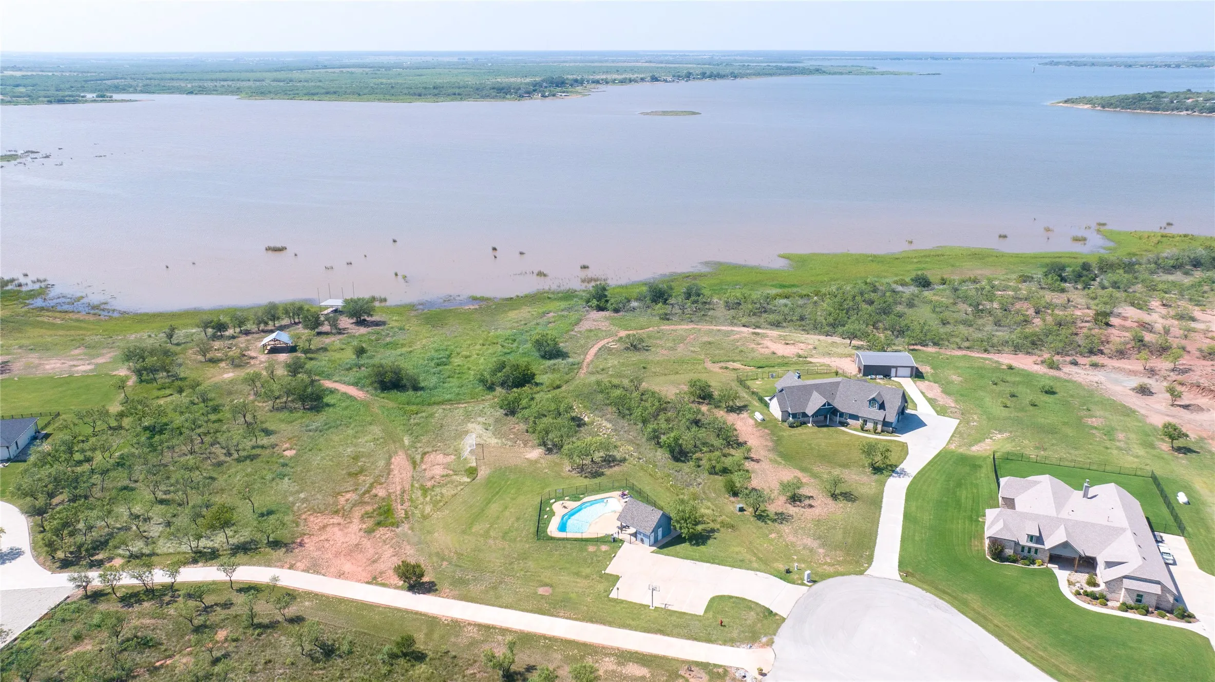 Facing north at the end of Aces Trail. Swimming pool, walking trail, covered gazebo and boat dock with lake access are all amenities in Lake Rock Trails.