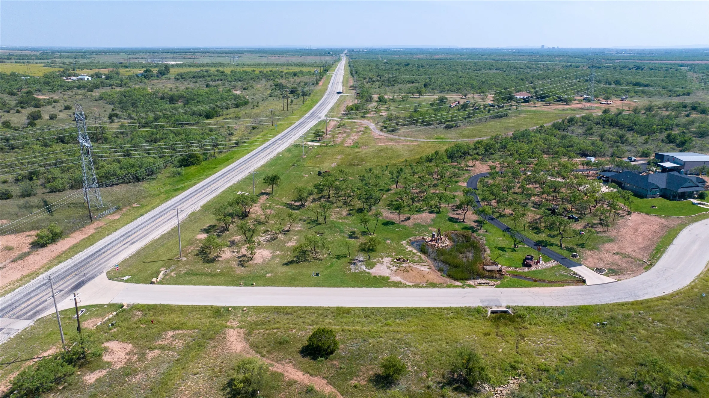 East Lake Road on the left. Aces Trail shown on the bottom of this photo. Lot includes the pond and shared use of the paved driveway to access the back of the property. Using this paved drive will save you from paying for a separate driveway!