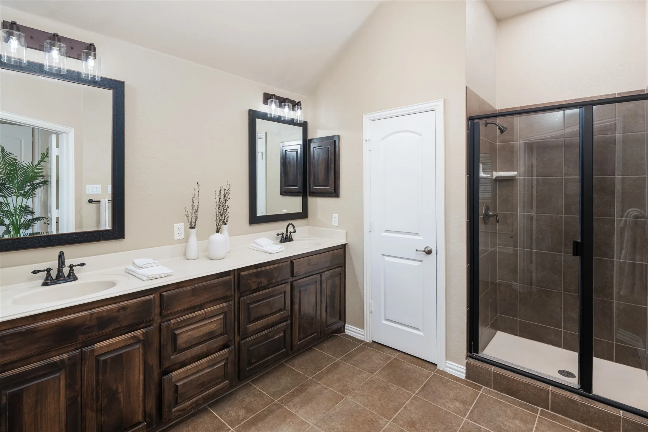 Primary bathroom.  Dual sinks and separate shower. Commode area is enclosed for privacy
