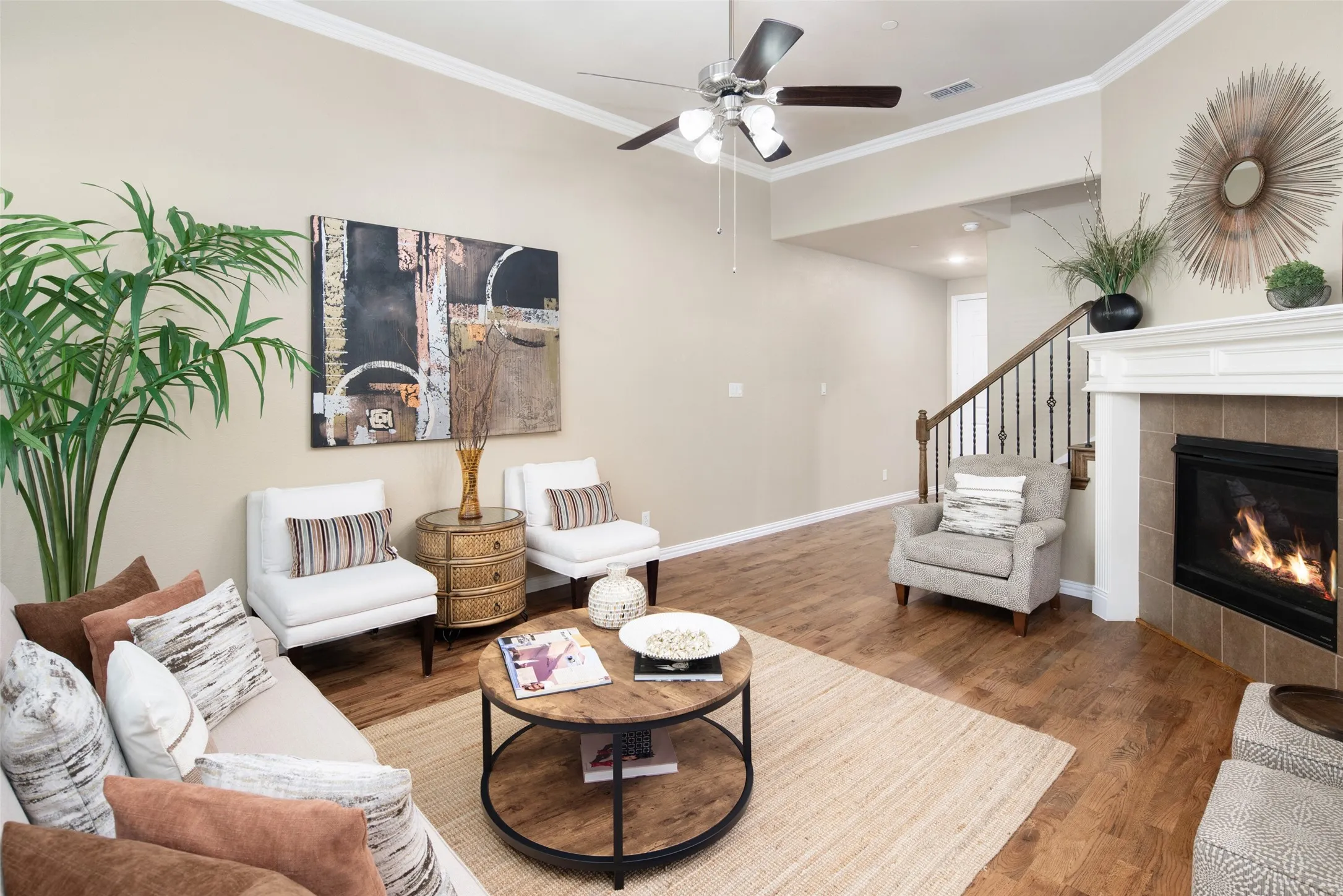 Spacious living space with ceiling fan.  Note the wrought iron spindles for an upscale look.