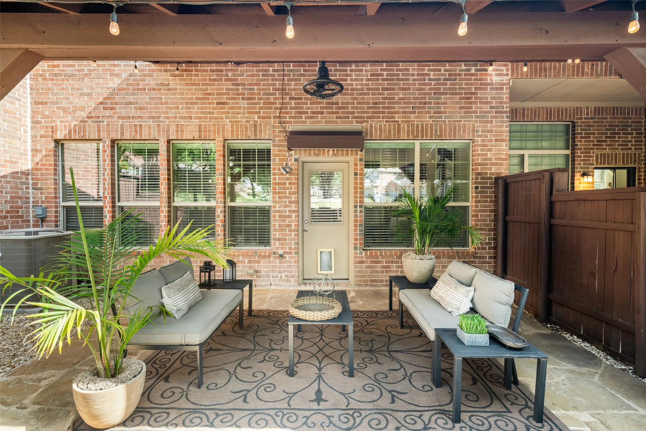 Patio with nice wood fence and ceiling fan