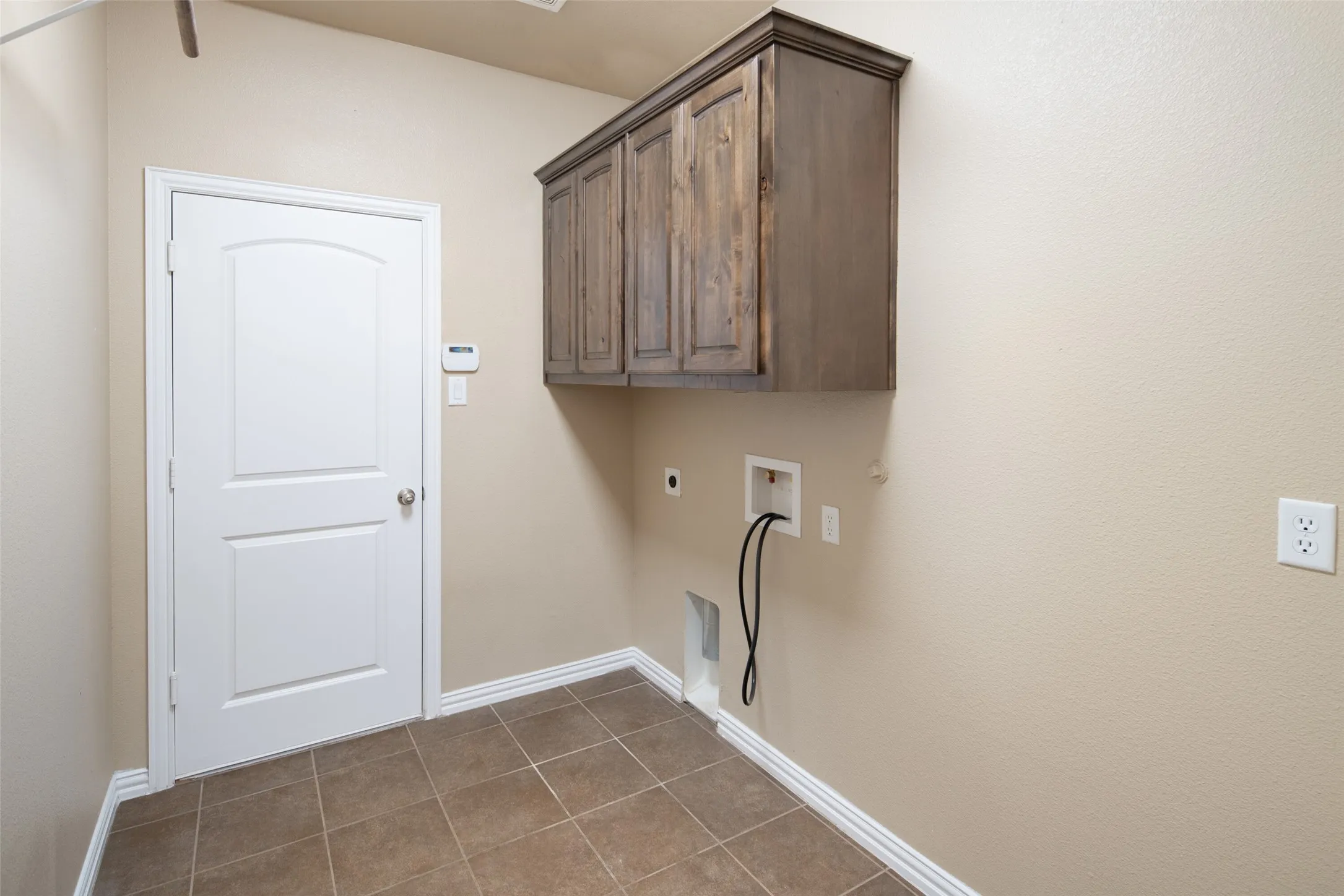 Large laundry area with cabinets above the washer and dryer area.  Room for a second refrigerator or even large enough for a chest freezer. Hanging space across from the washer and dryer