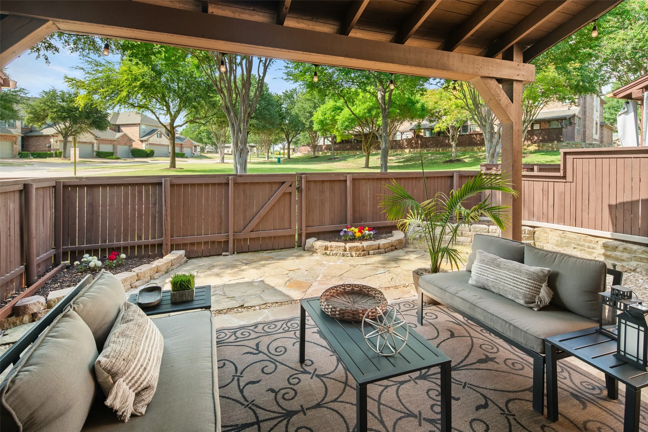 Oversized covered patio looking out at the treed green space