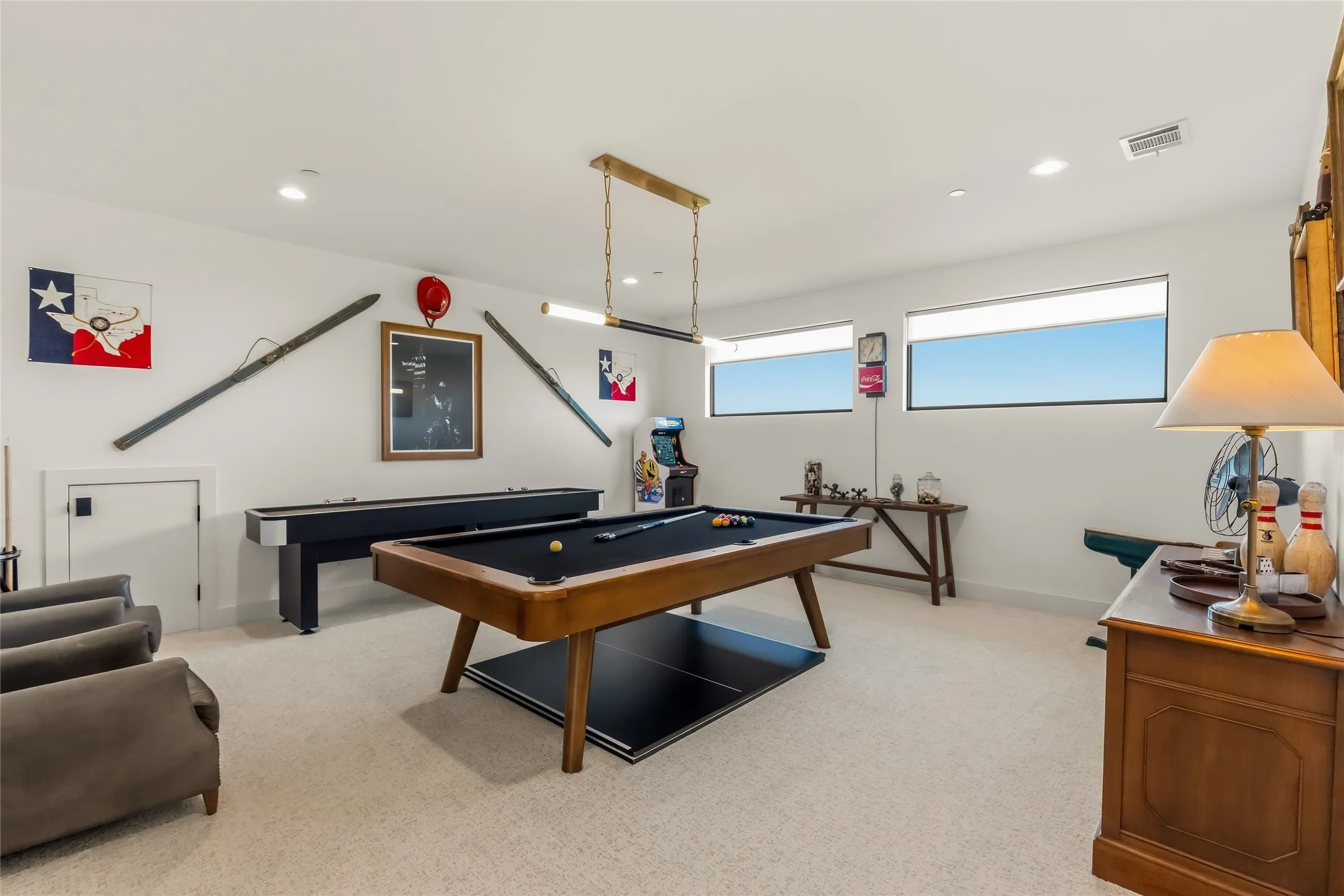 Recessed lighting, light-colored carpeting, and three transom windows