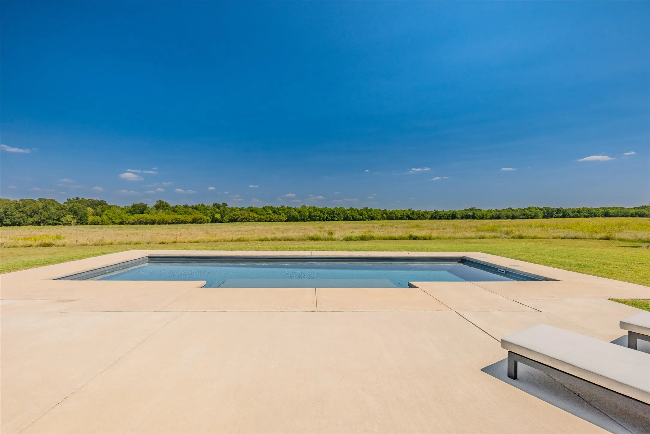 Rectangular inground pool with concrete surround
