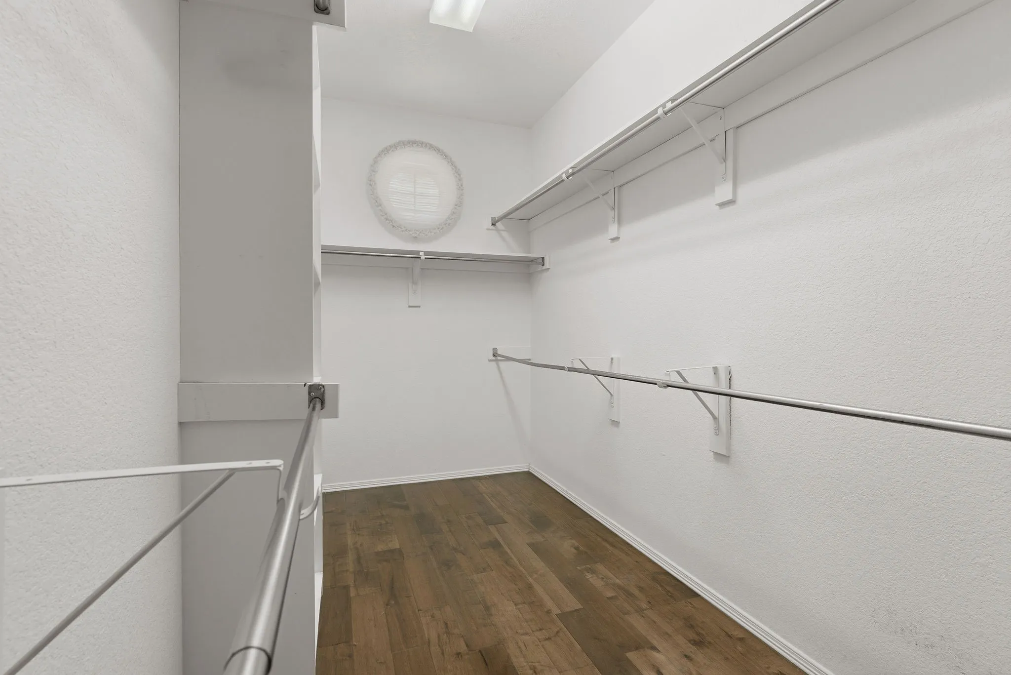 Primary bedroom walk in closet