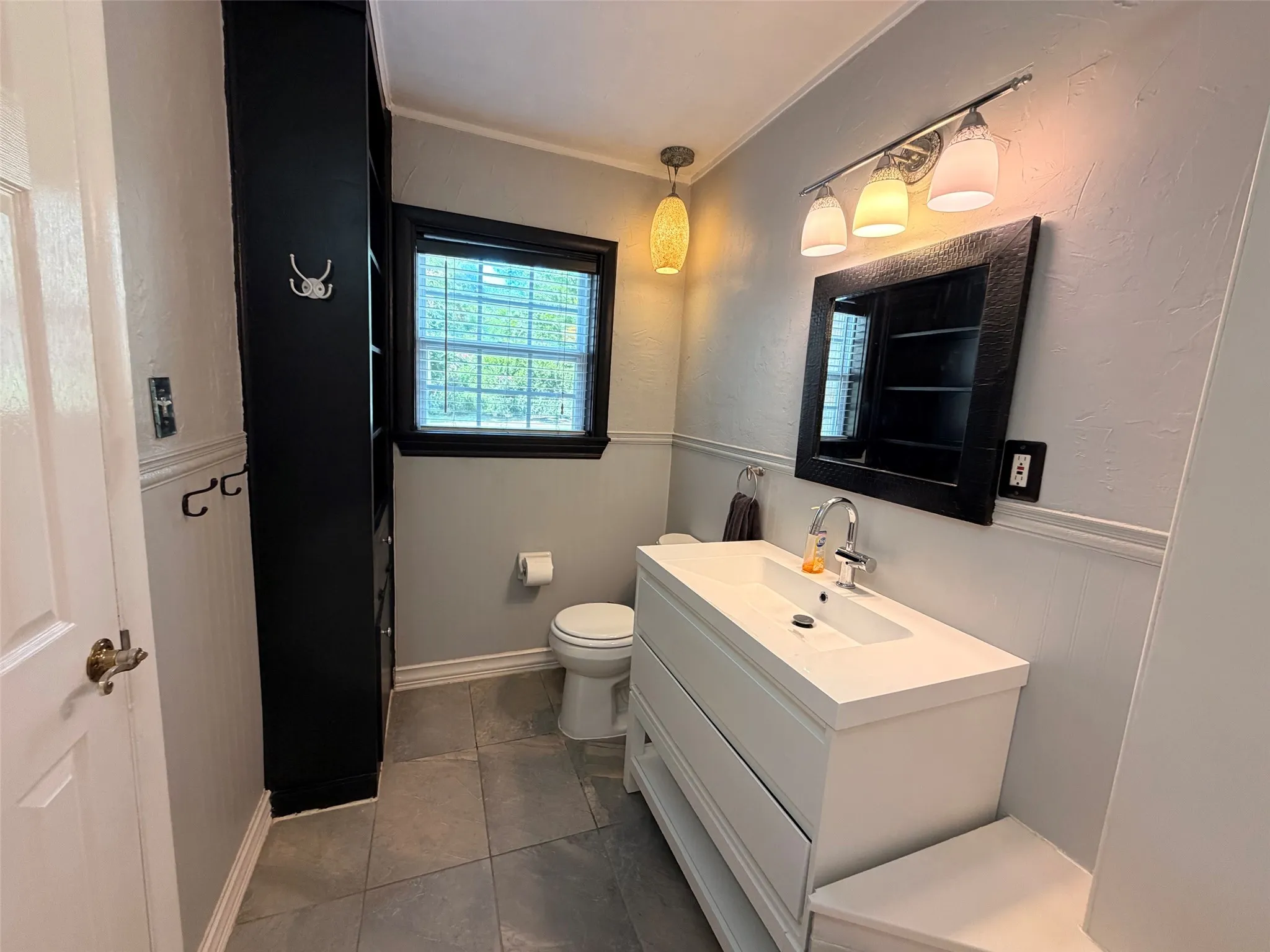 Modern vanity with an integrated rectangular sink, chrome faucet, and storage drawers
