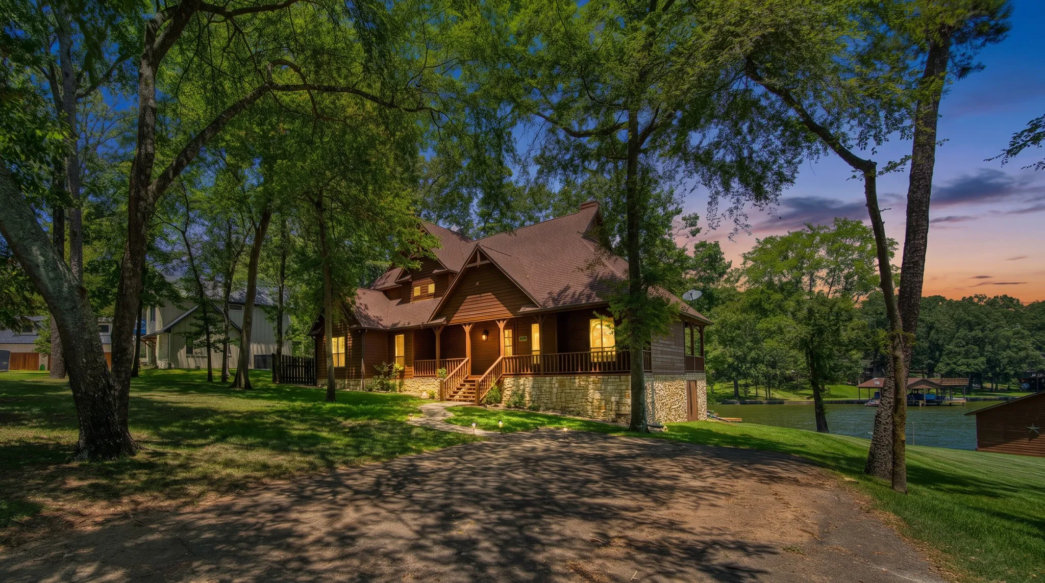 Wood-sided home featuring a stone foundation and a covered porch
