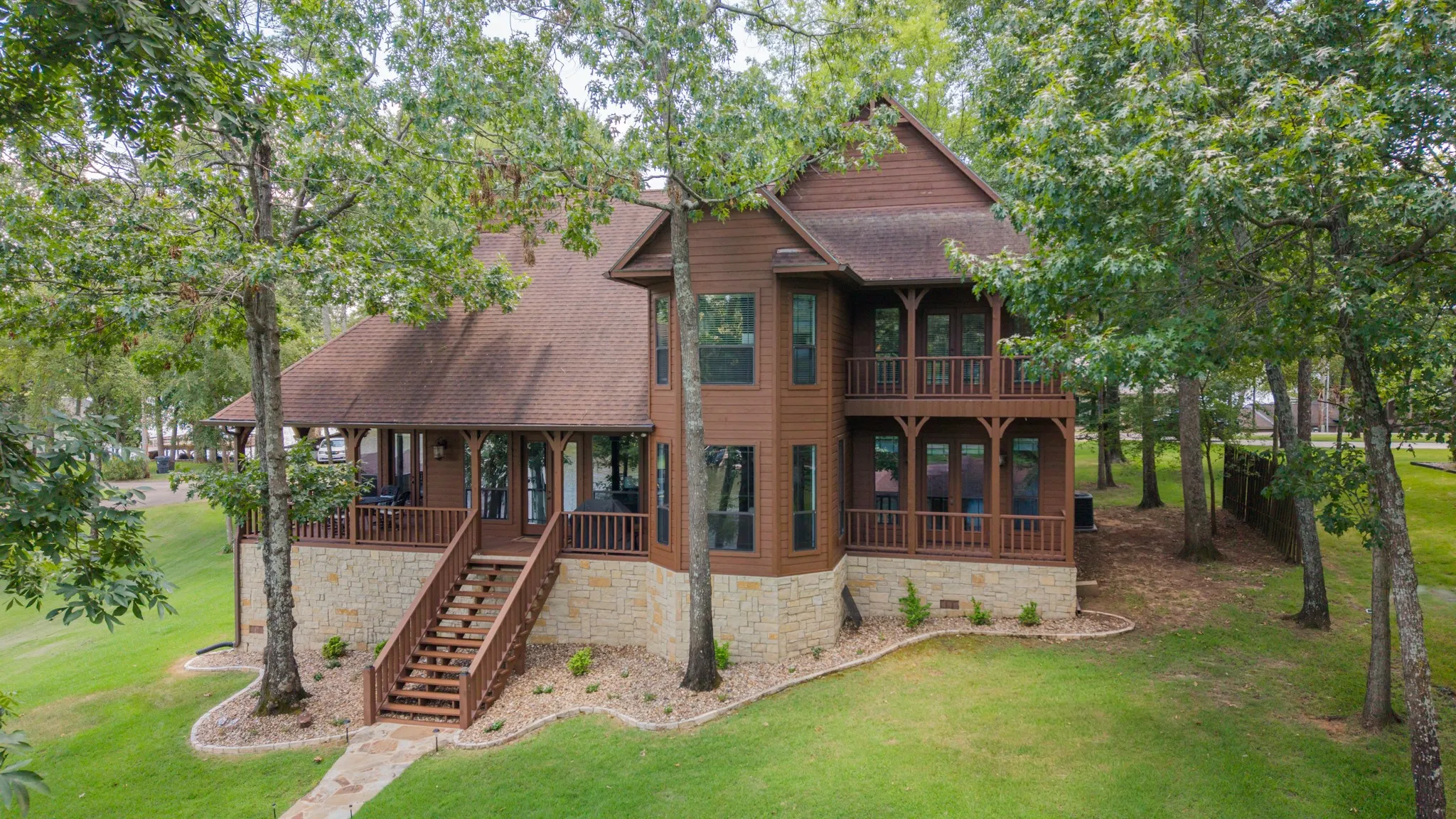 Multi-level exterior with wood siding and stone accents