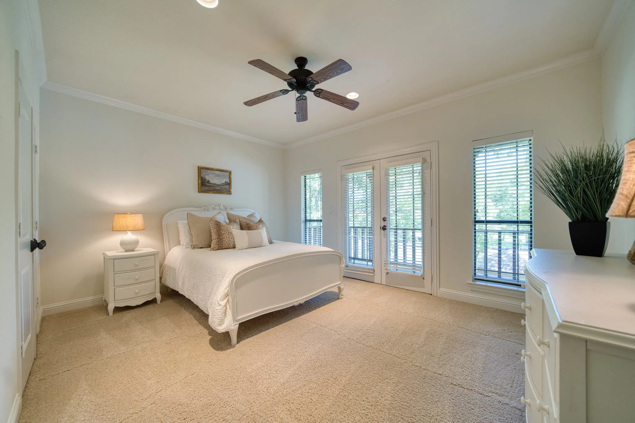 Vaulted ceiling with crown molding, double French doors, single window, recessed lighting, and a ceiling fan