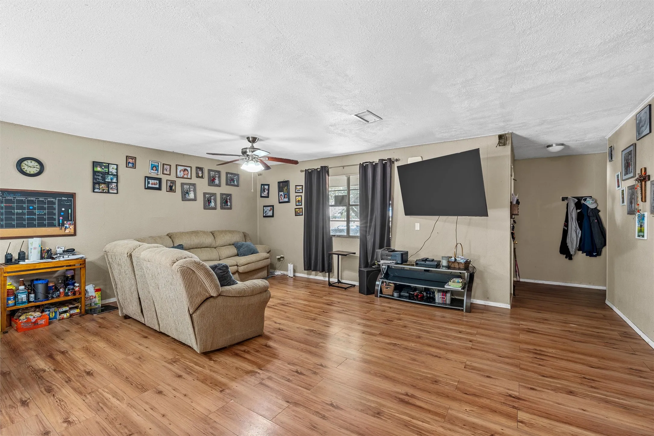 Wood-finish flooring throughout, complemented by neutral wall tones
