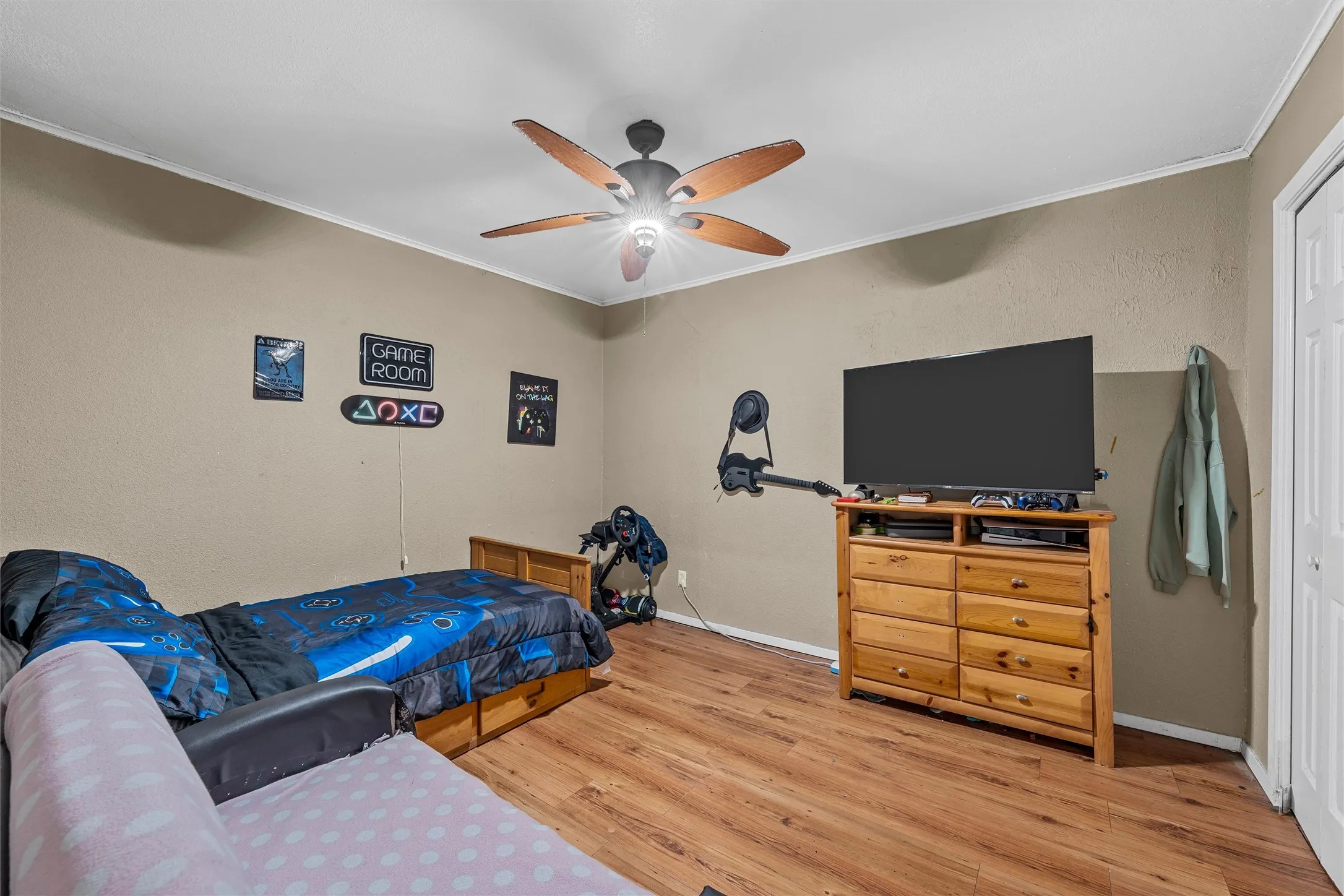Wood-finish flooring with a ceiling fan light fixture