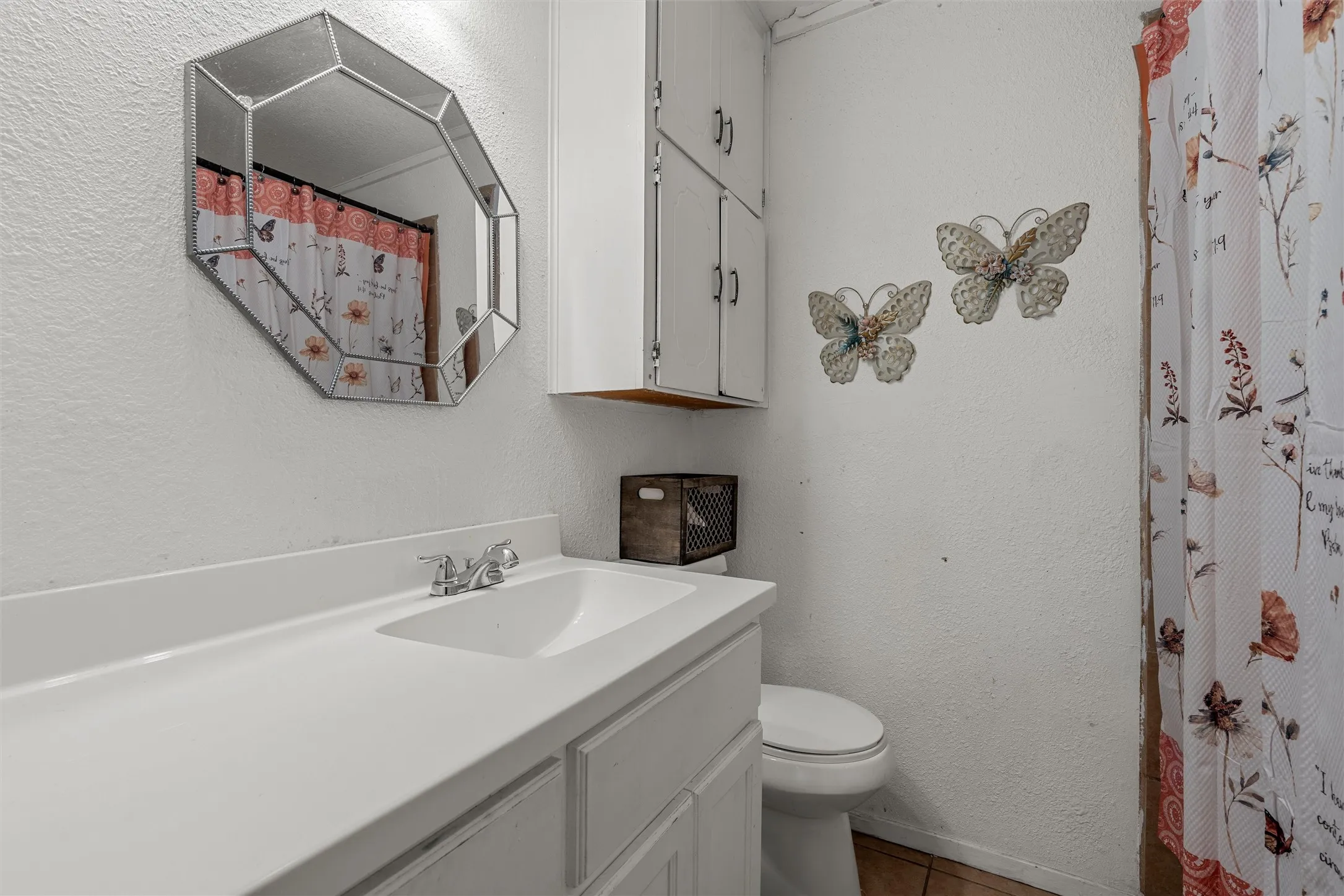 White vanity with an integrated sink and chrome faucet