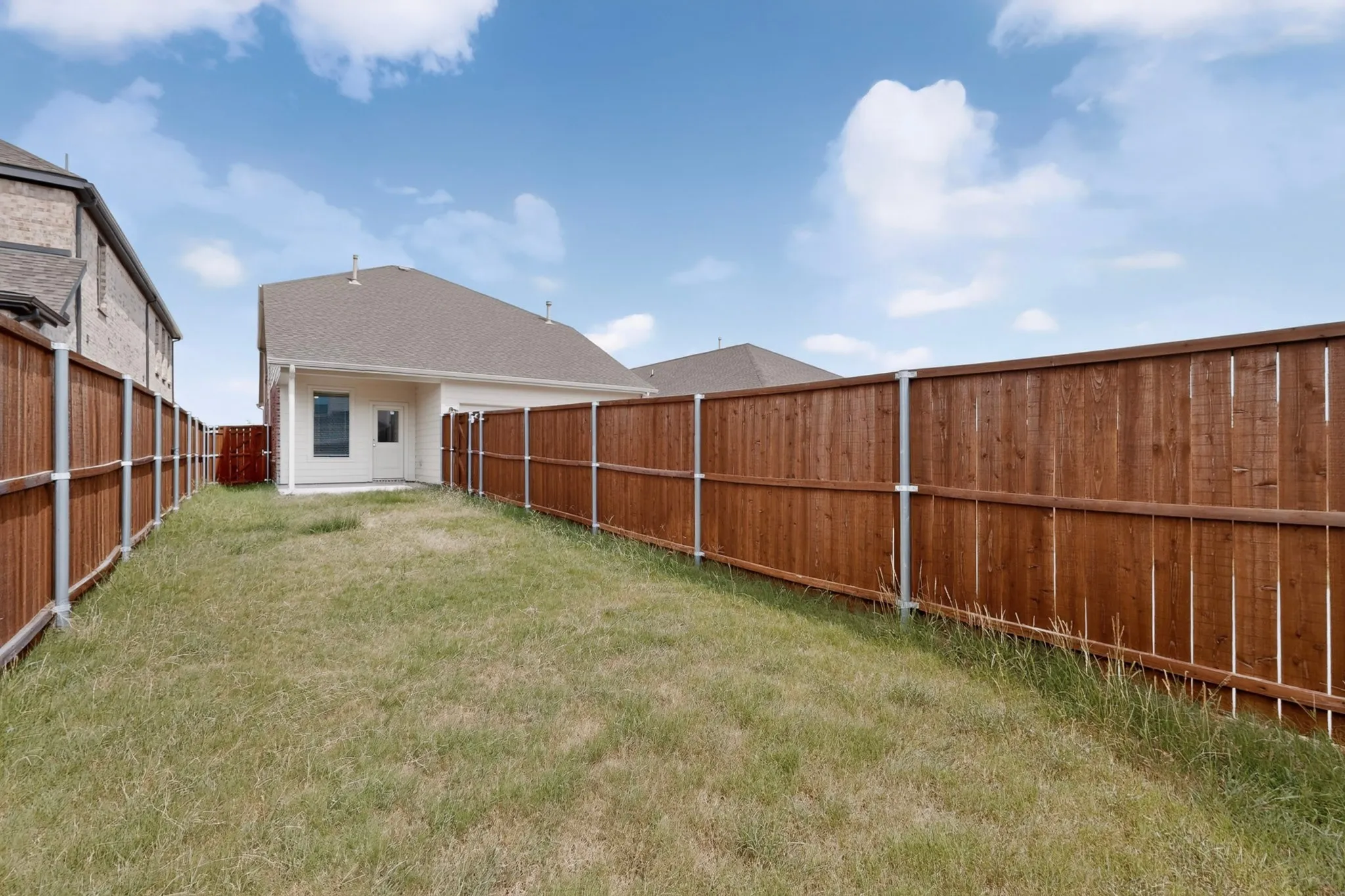 Private backyard with wood fencing and a concrete patio
