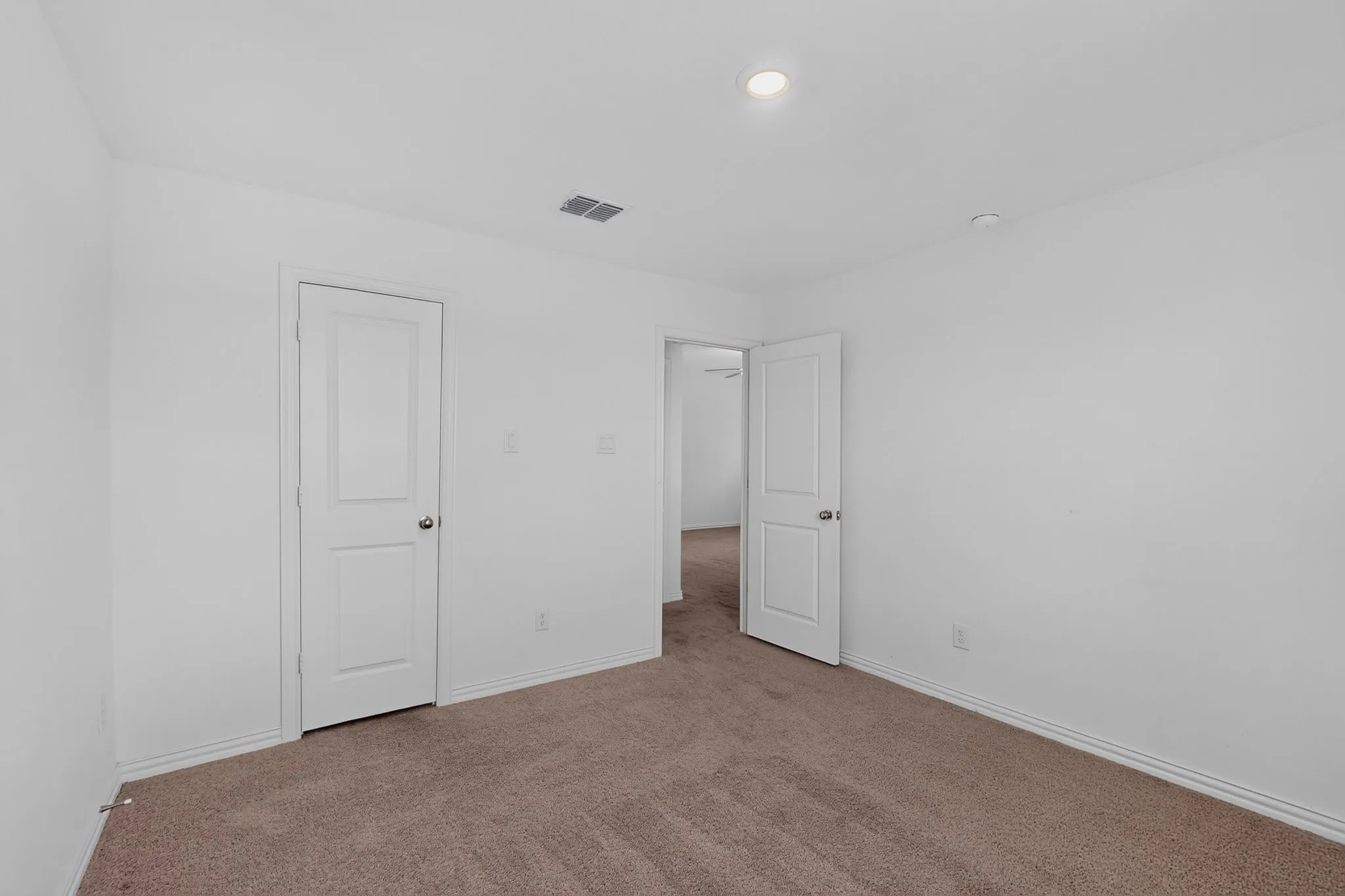 Neutral paint palette, recessed lighting, and carpeted flooring
