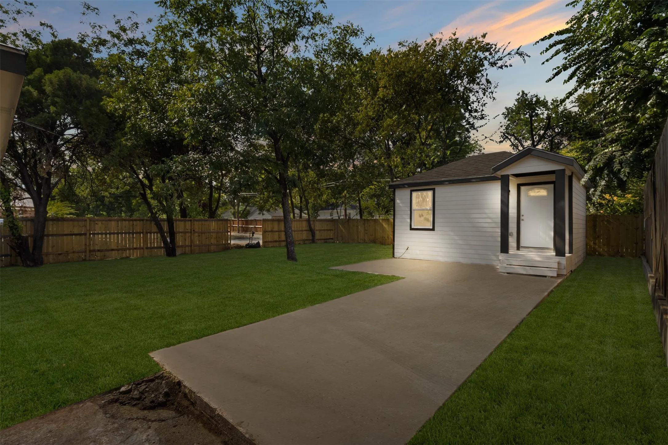 Single-story residence featuring white siding and a covered front entry