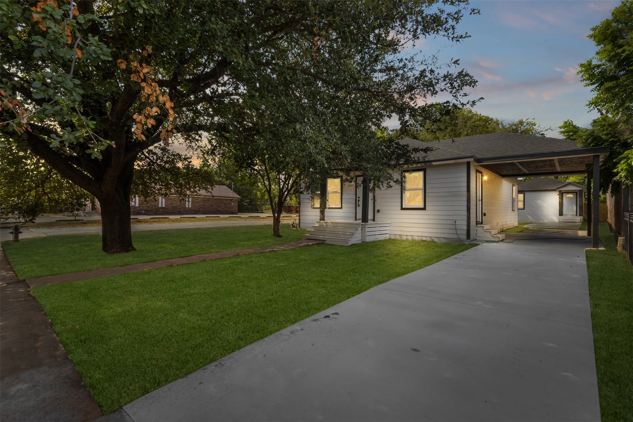 White exterior siding with dark trim windows