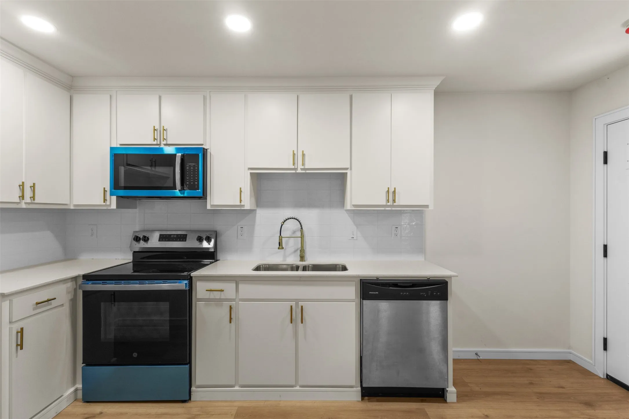 White cabinetry with gold-tone hardware