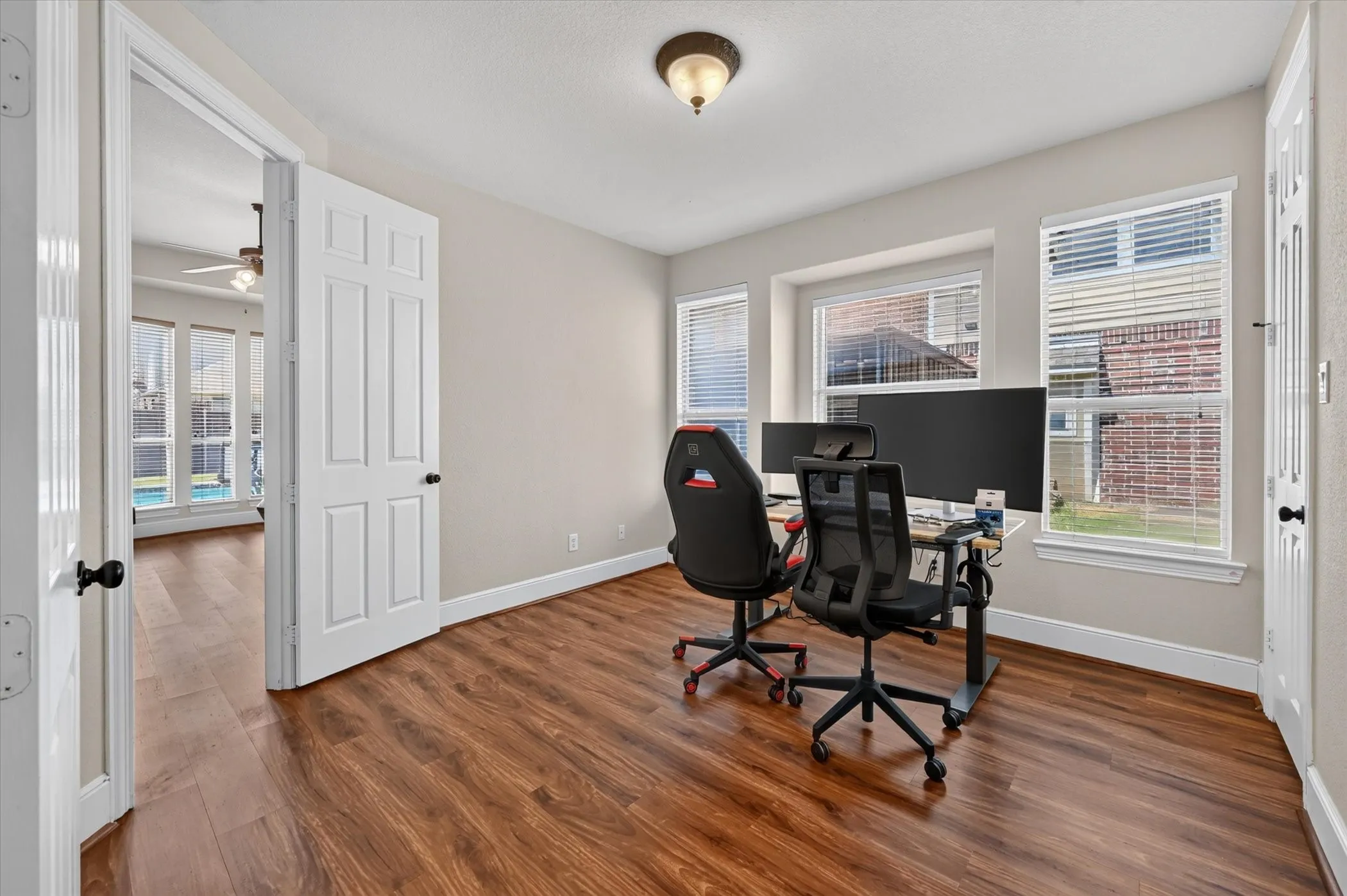 Warm wood-finish flooring complements the neutral wall color