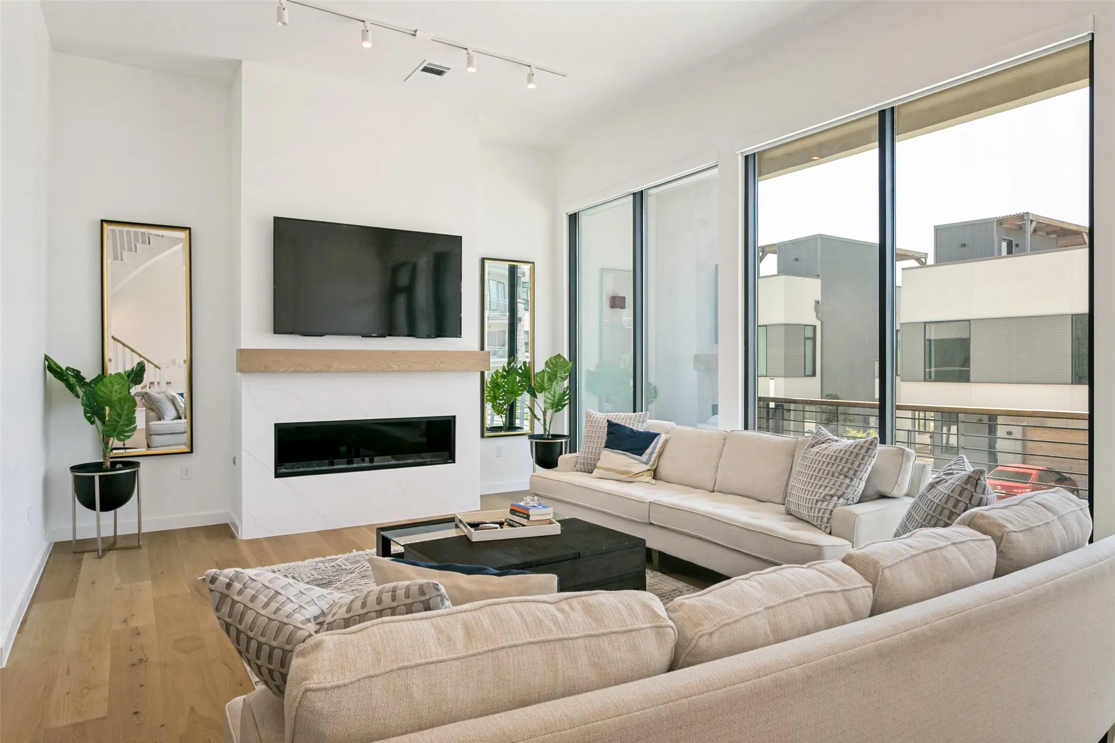 Open concept living room offering an inviting setting for relaxing and entertaining. Also has access to 2nd floor patio space.
