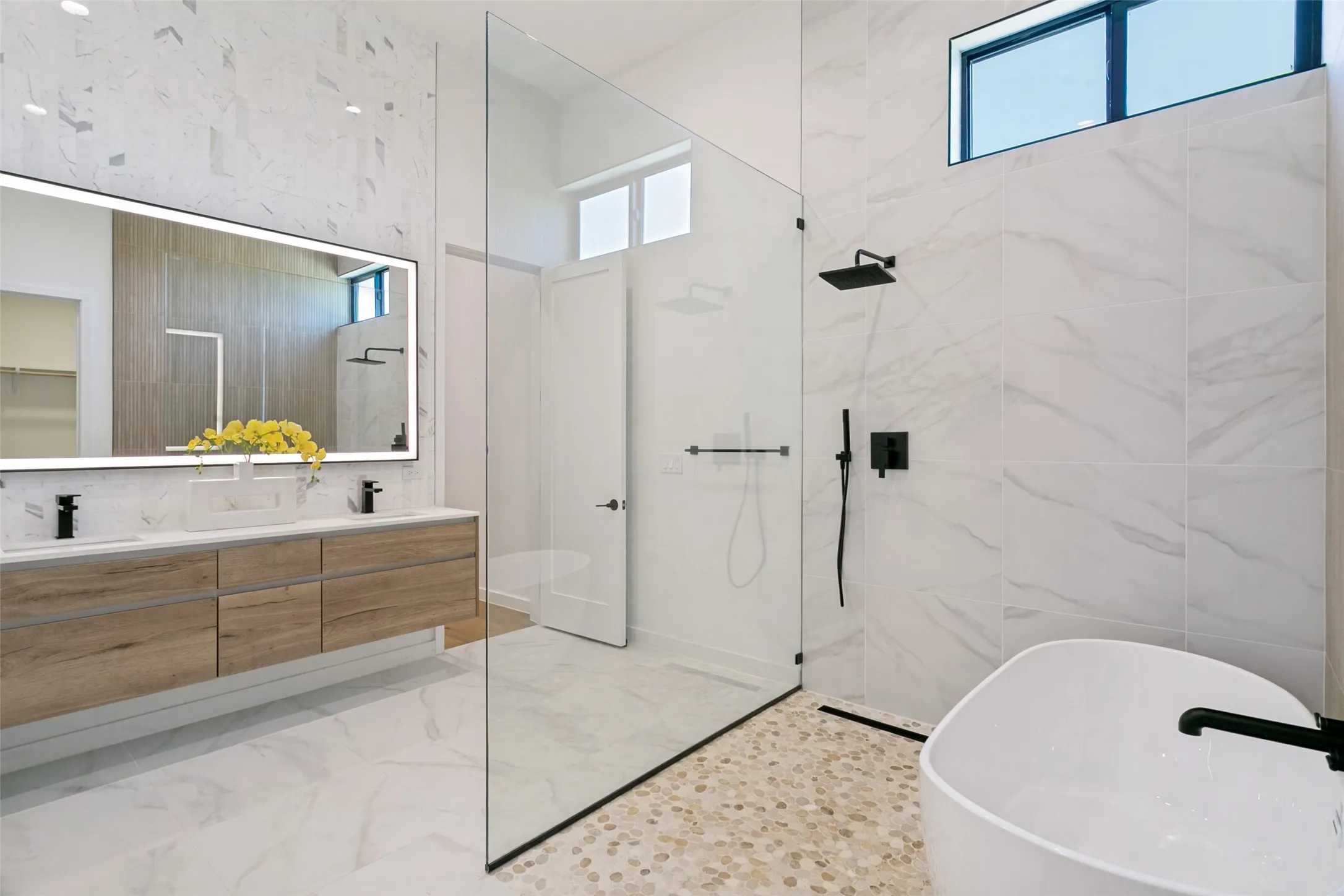 Primary bathroom with large shower/bath area. Large walking closet and 2nd utility room attached.