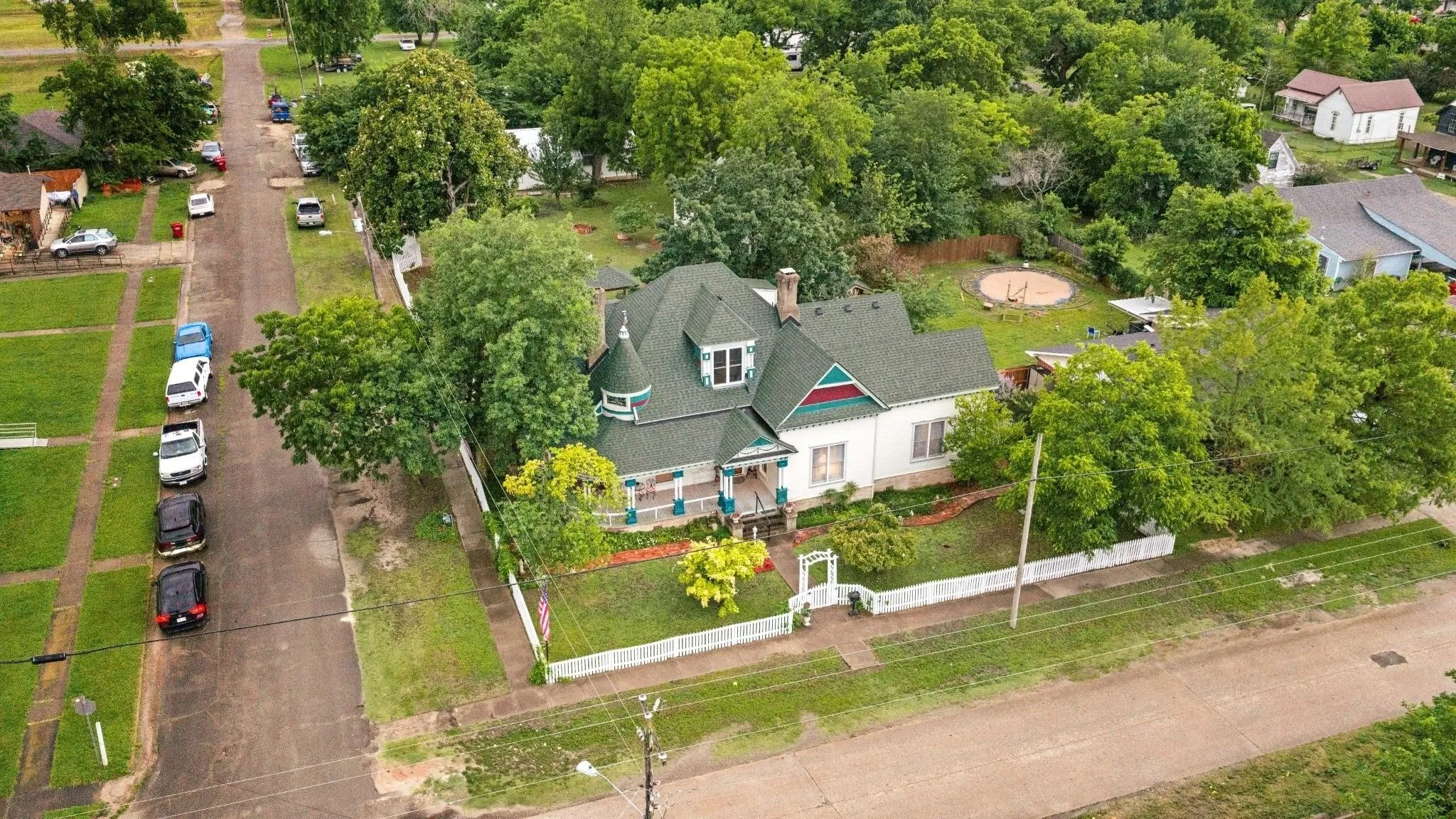 Victorian-style residence featuring a prominent turret, front porch, and pitched roof