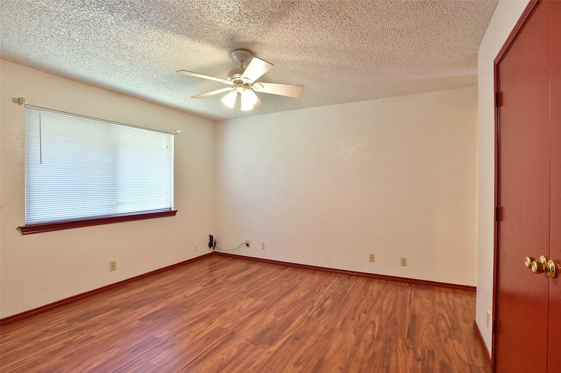 A large window brings in lots of natural light to the primary bedroom.