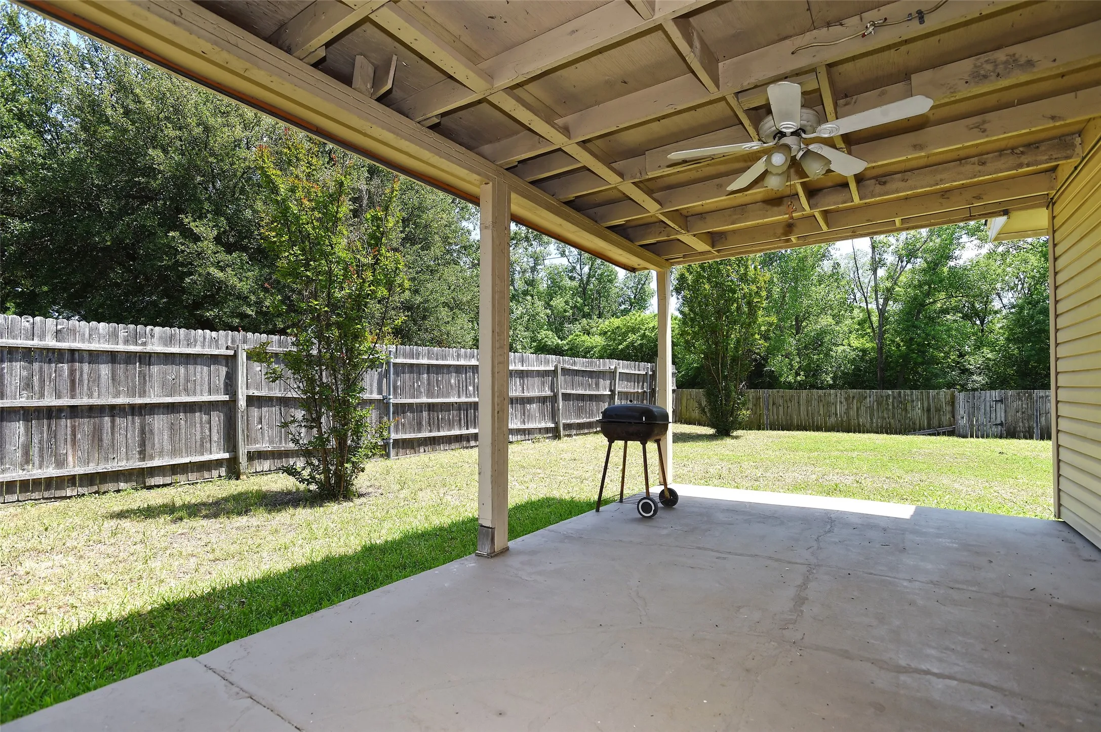 The large covered patio with a ceiling fan gives you even more living space.