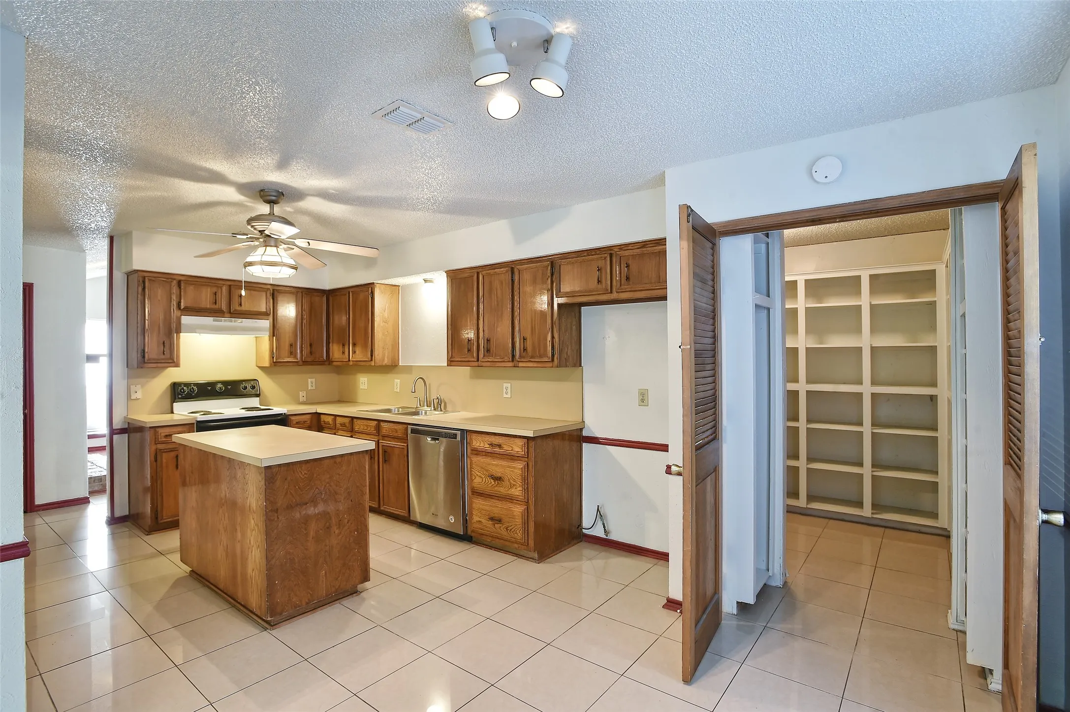 View of the kitchen, dining area and into the pantry/laundry room.
