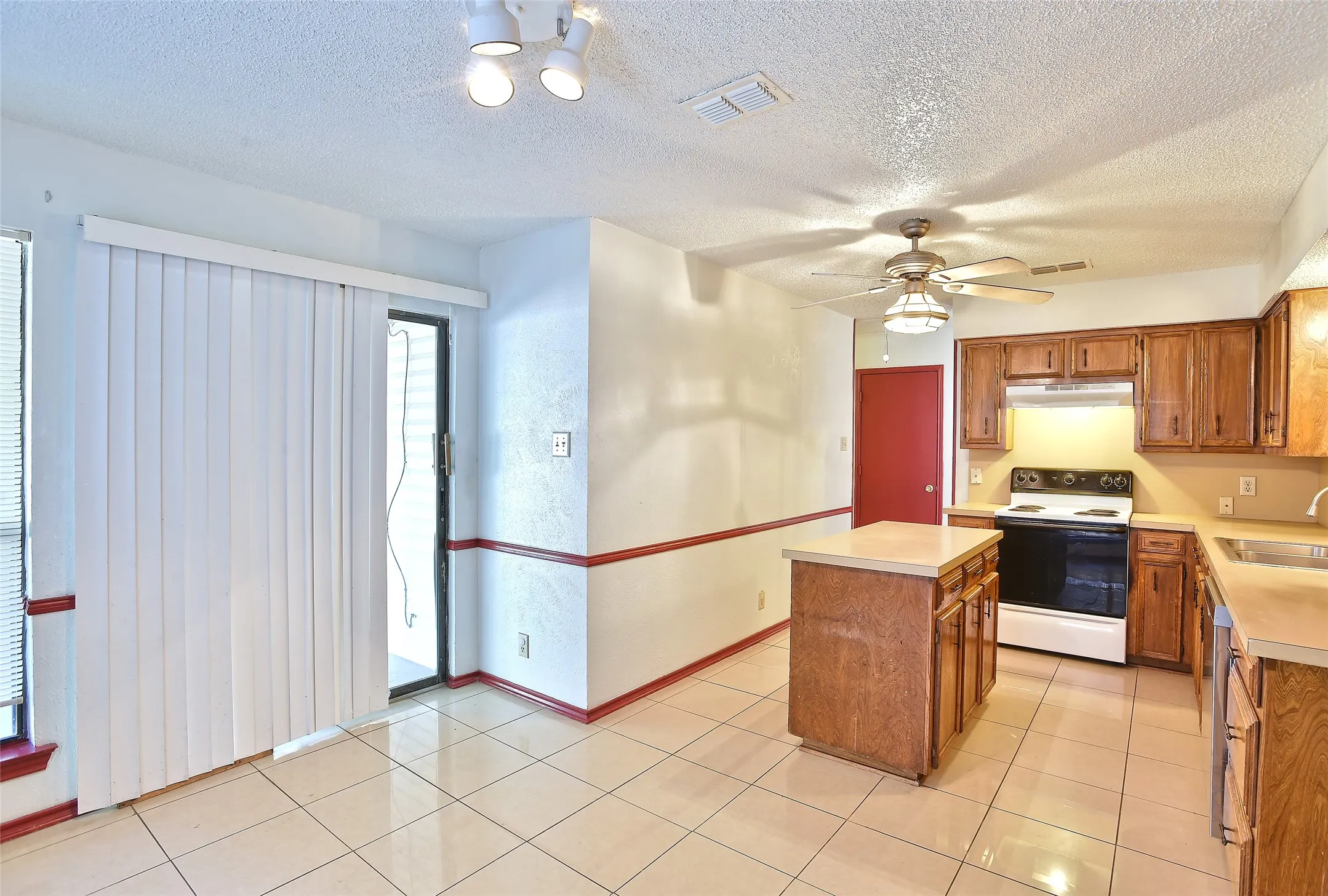 The dining area is just off the kitchen.  Access the backyard through the sliding glass doors.