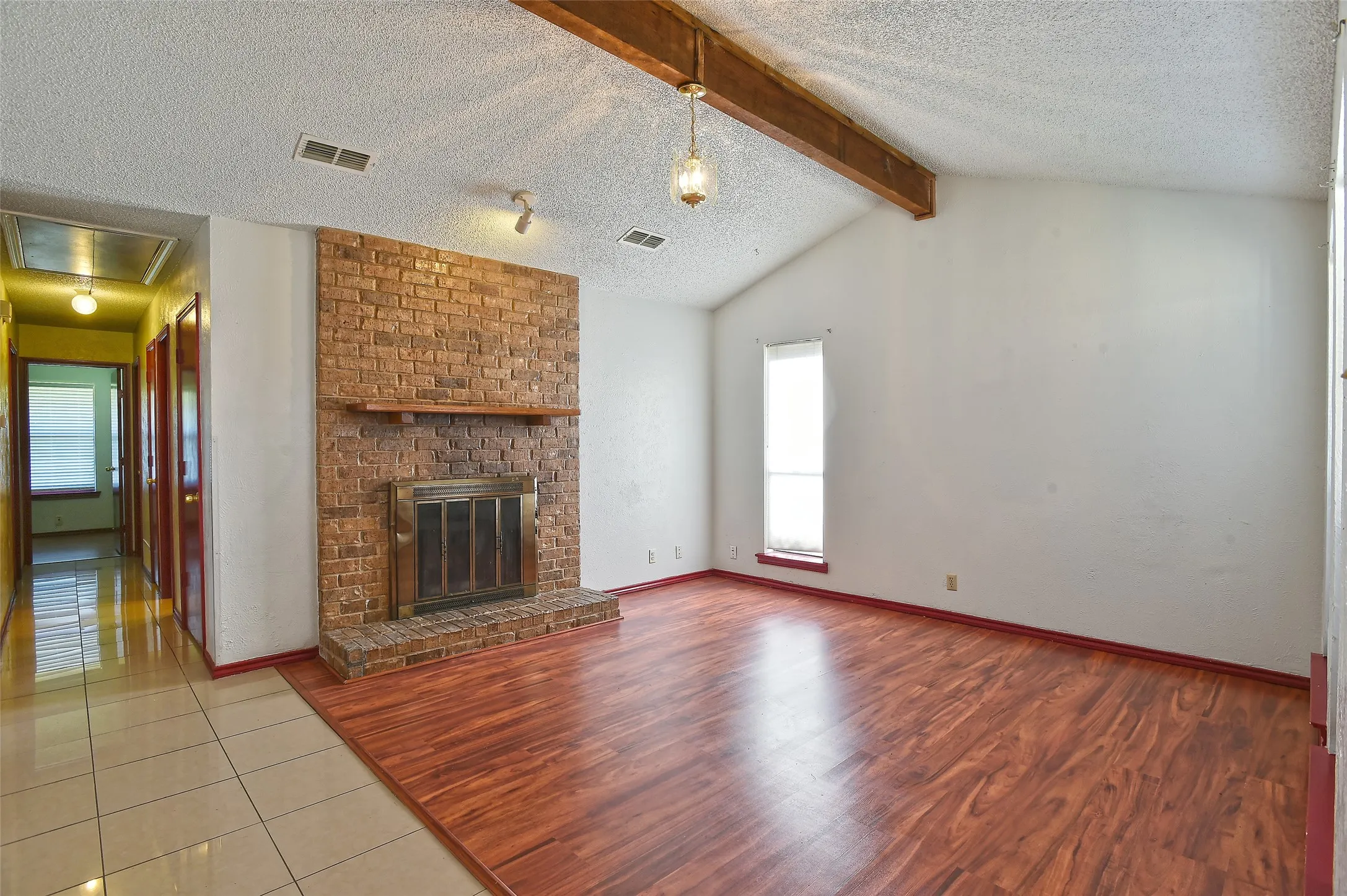 The fireplace and vaulted ceiling are the focal points of the living room.